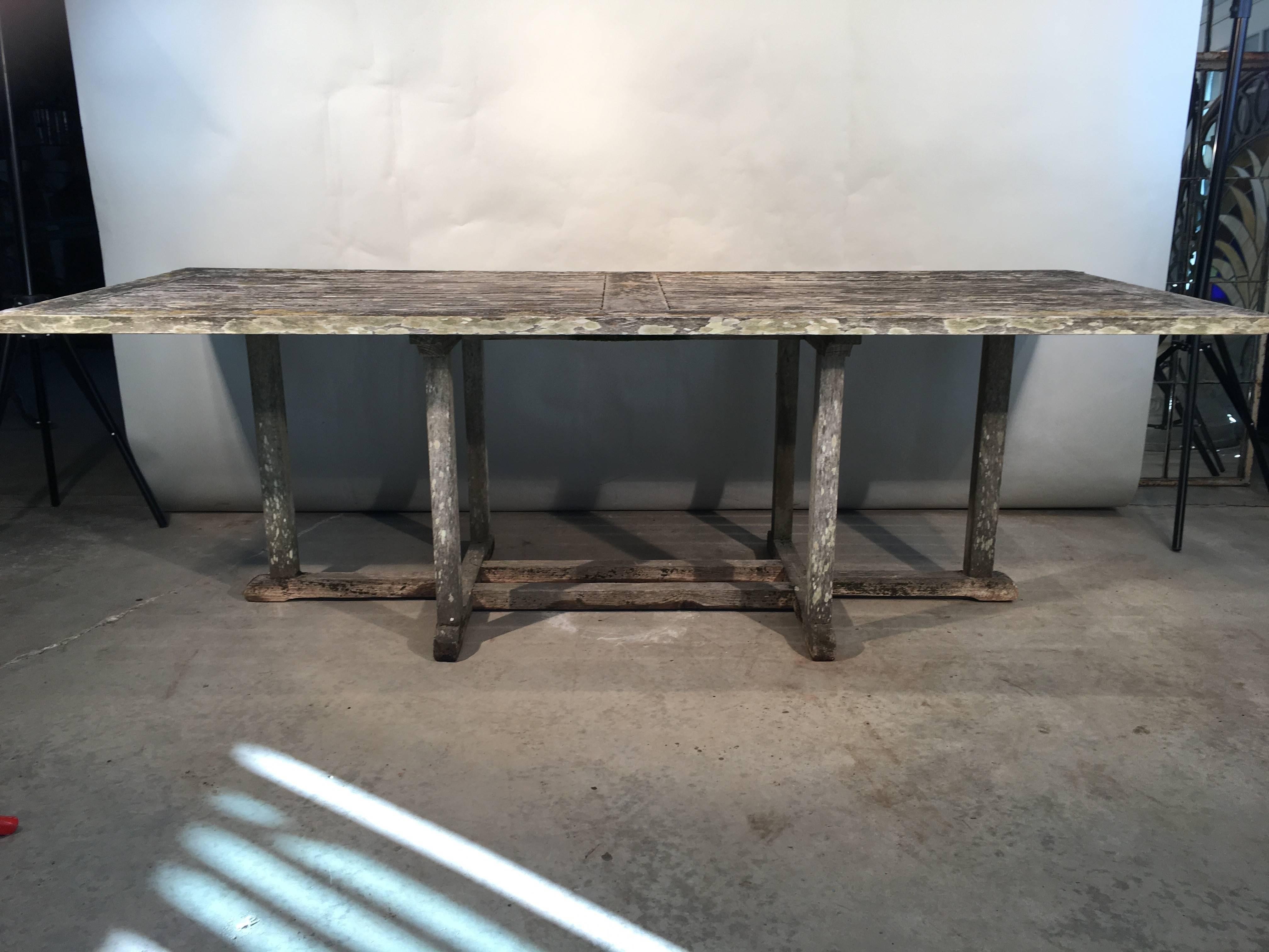 This large rectangular teak table will seat 8-10, and it features a lovely weathered surface that is clean enough to dine on but does not disappoint patina-wise. It is very solid with tight joints and has no wobble to it. Place it in your garden or