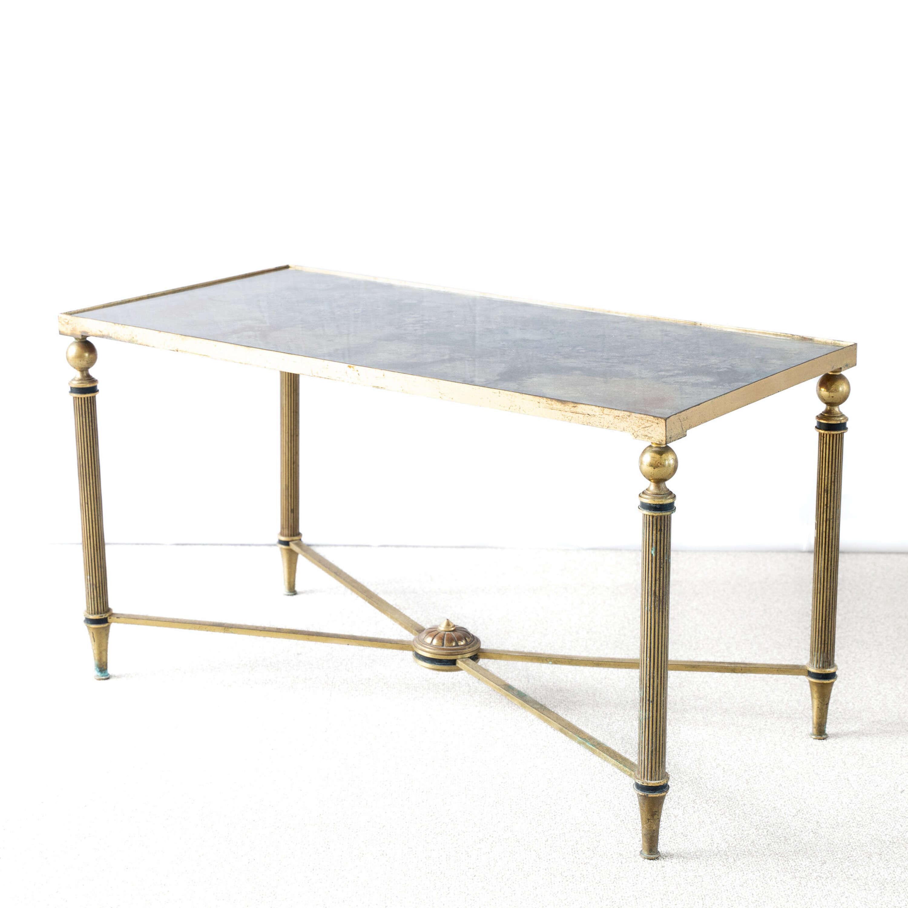 A French Brass Coffee Table with a verre églomisé top, sitting on tapered legs.
Attributed to Maison Jansen.

France, circa 1960.

Height - 44.5 cm
Length - 80 cm
Depth - 40 cm
Please message if any further info or photos are required 
SHIPPING
The