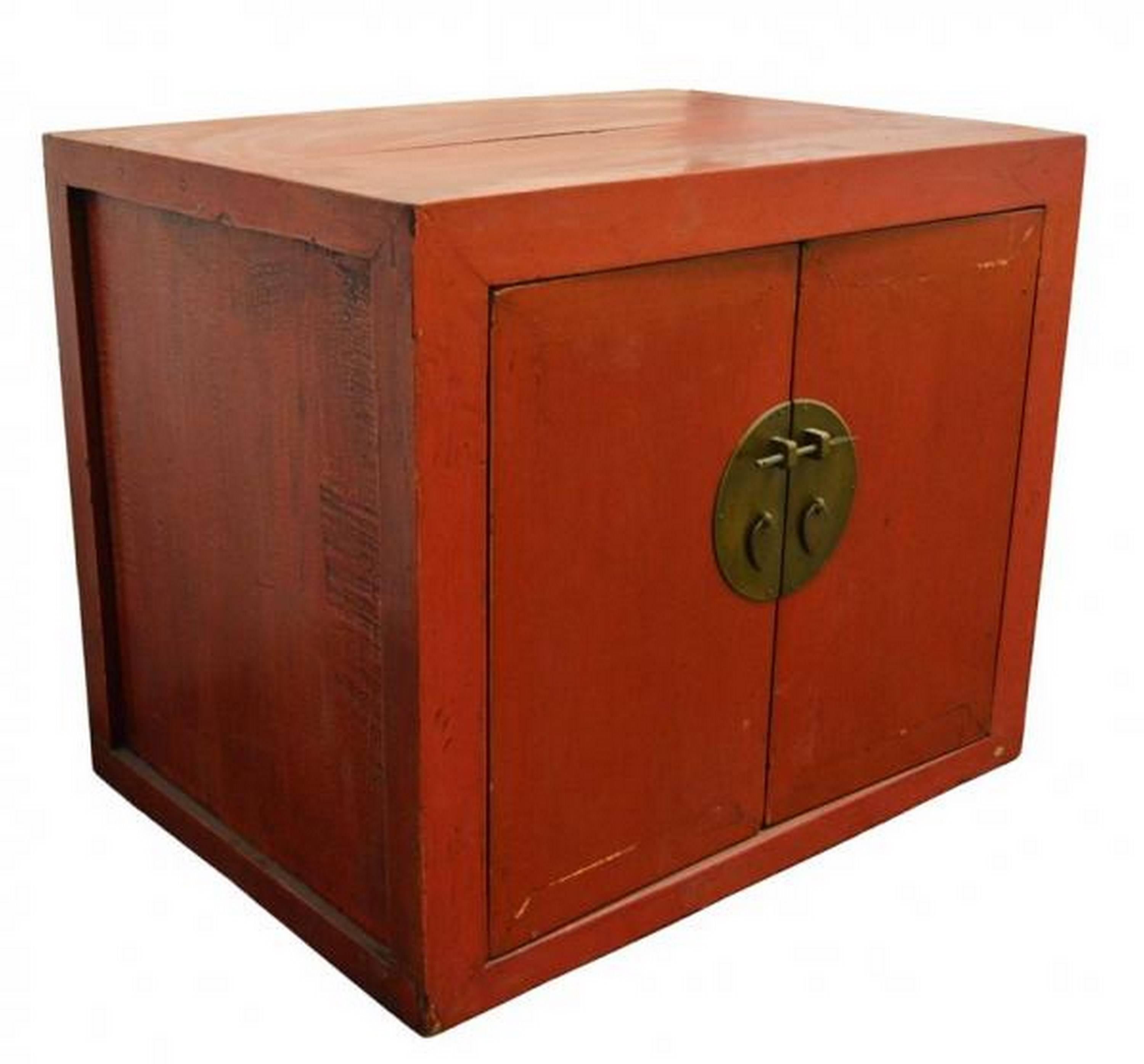 This beautiful 20th century Chinese lacquer cabinet is characteristic of the Chinese style of this period, thanks to its gorgeous red color and its elegant simplicity. The cubic shape of this cabinet is only livened up by the light recess of its