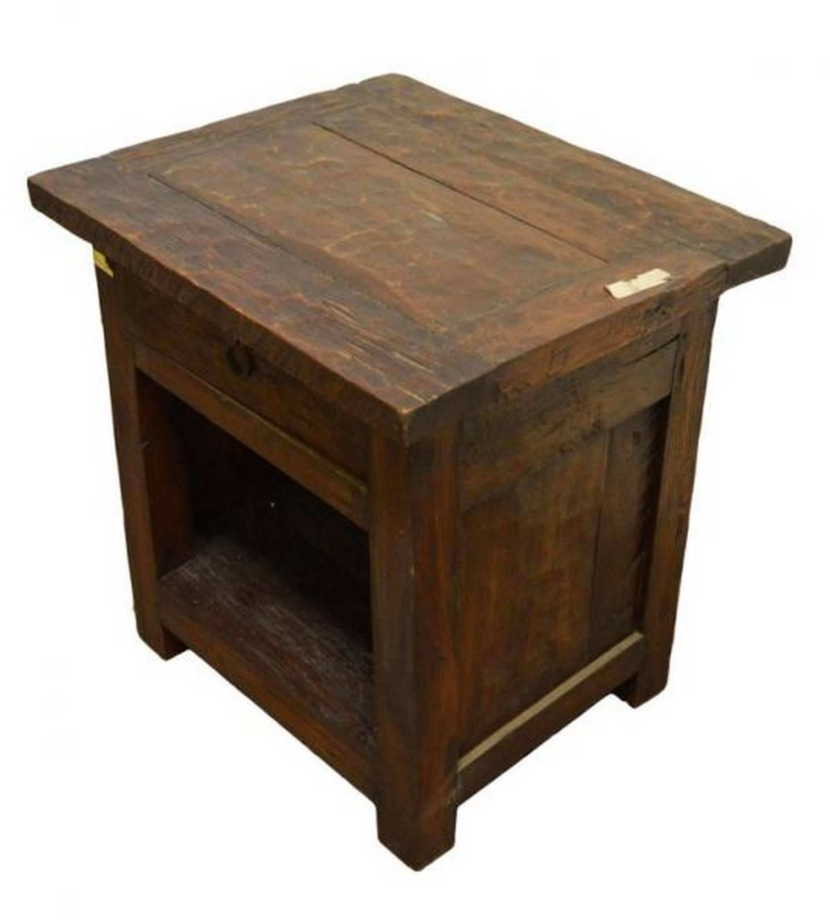 A 19th century rustic bedside table / cabinet with drawer and storage from Java, Indonesia. This small cabinet features a simple square top on a plank structure. The front displays a unique top drawer with a round pull handle and an open storage