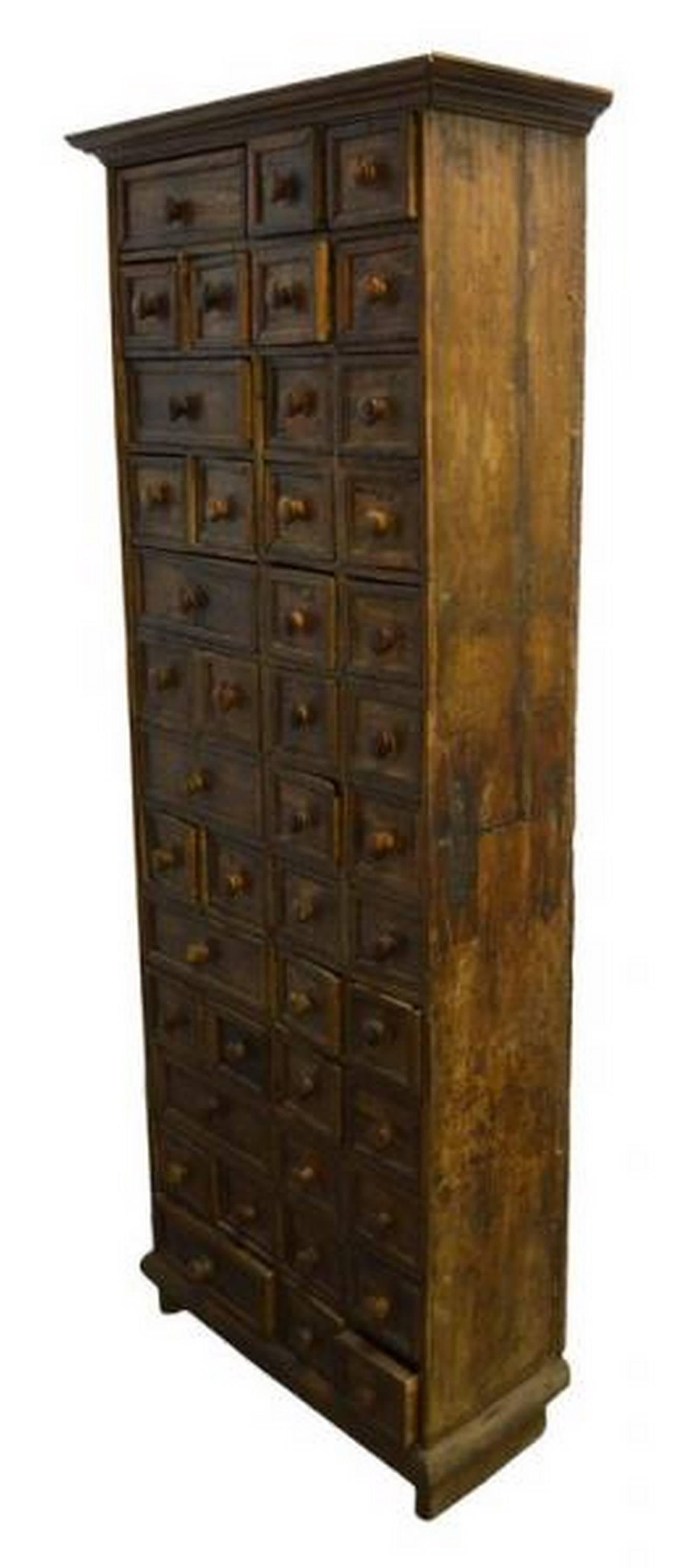 A stained wooden apothecary cabinet from 19th century Indonesia.  This hand carved apothecary cabinet comes with 45 drawers, 38 of them being square in size and 7 being double sized (as in side by side).  The drawers open thanks to simple round