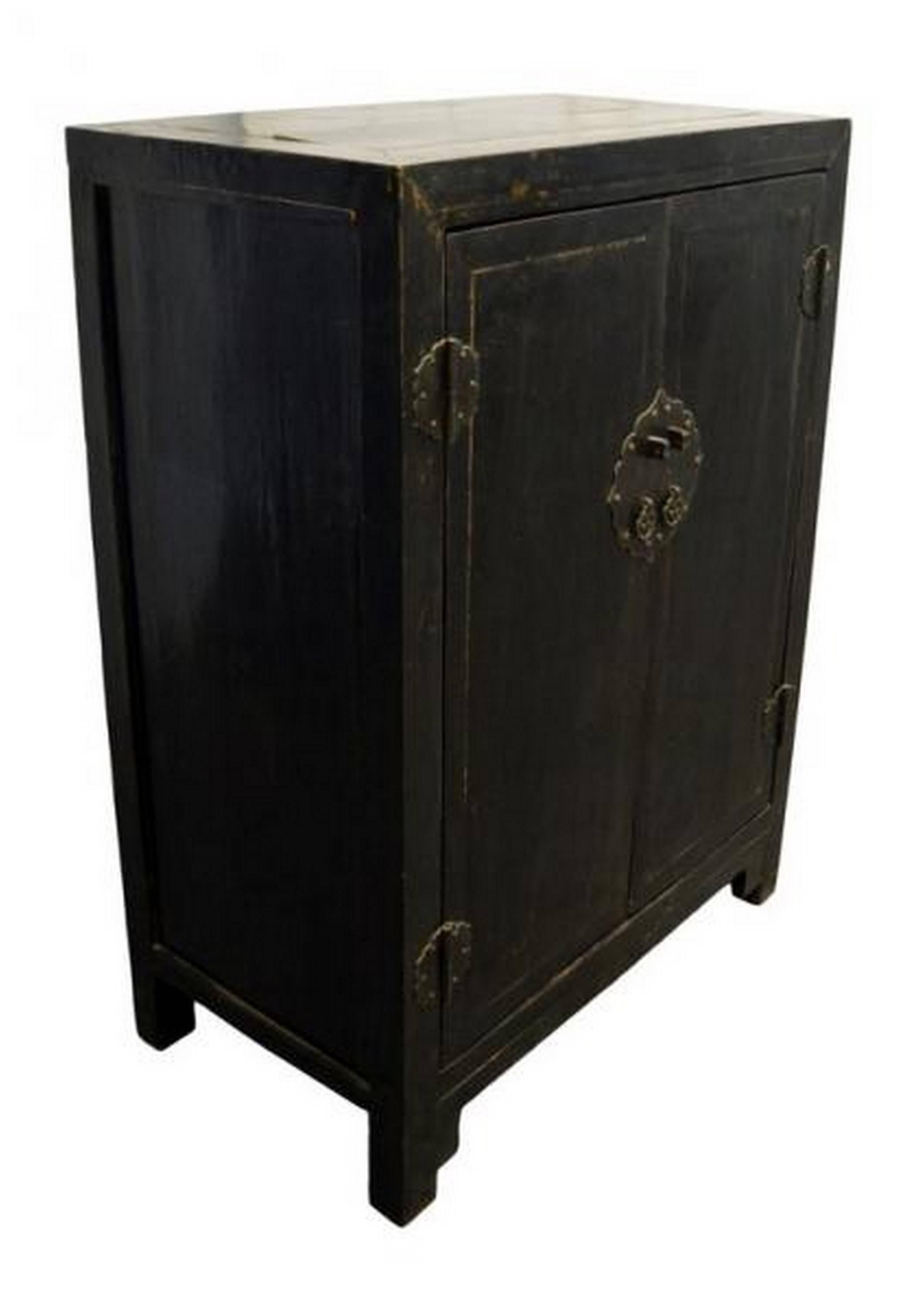 A 19th century Chinese side cabinet with black lacquered wood and brass hardware. This cabinet adopts a typically Chinese refined rectangular shape. The two doors open thanks to a carved brass hardware lockset with two ring pull handles. The four