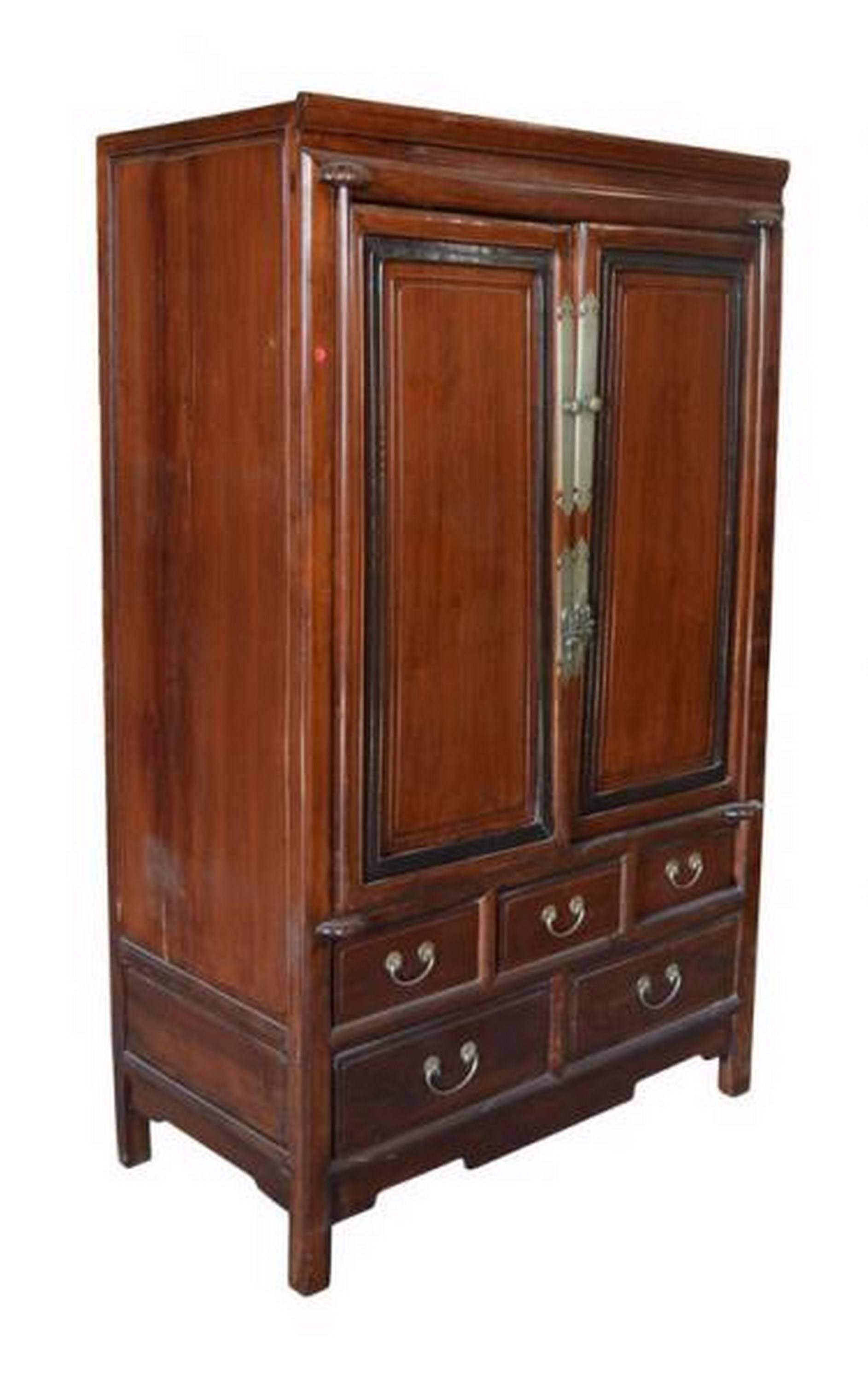 A Chinese mid-19th century cabinet made with lacquered blackwood and rosewood. This tall cabinet adopts a rectangular shape and features the contrasting details of rosewood and blackwood. The front features two doors with carved brass pulls on