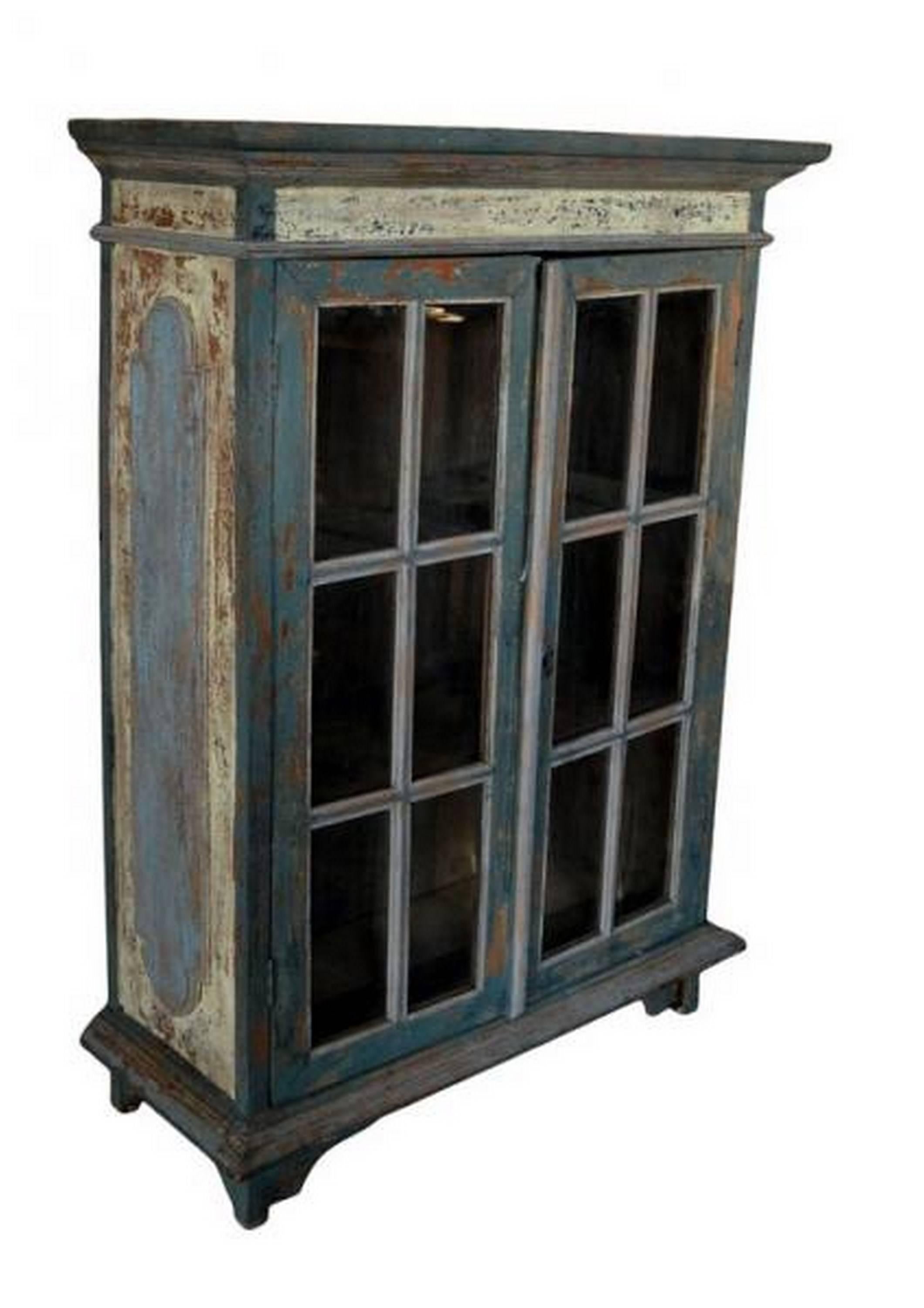 A rustic cabinet with glass doors hand carved in the Goa state of India. The rectangular shape of this cabinet is emphasized by the cornices on the top and bottom. The cabinet stands on four legs and is adorned with carved panels on its sides. This