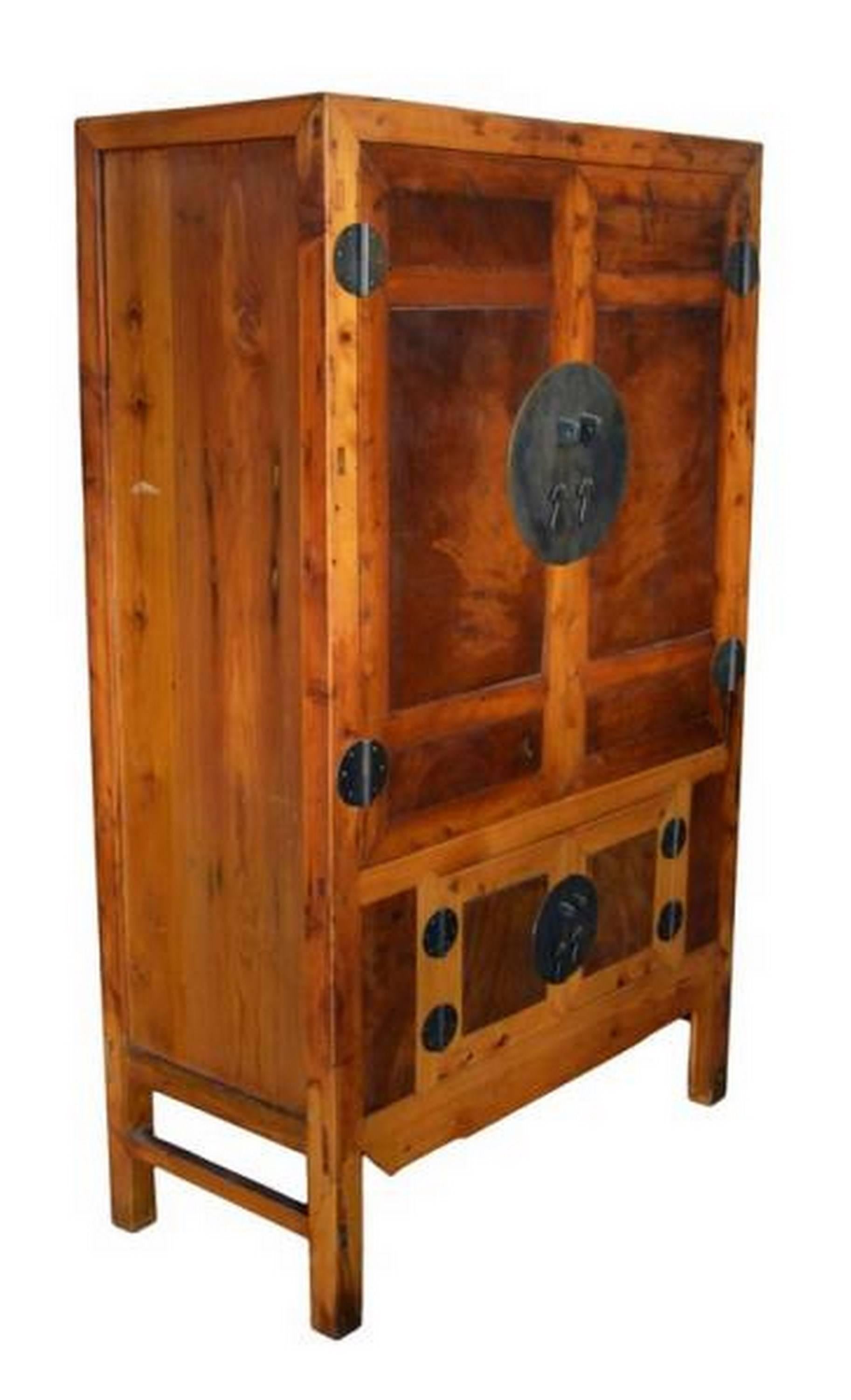 An antique armoire with burl wood panels and original brass hardware from 19th century China. This Chinese antique armoire was made with inset burl wood panels and brass hardware. The armoire adopts a traditional Chinese shape with a rectangular