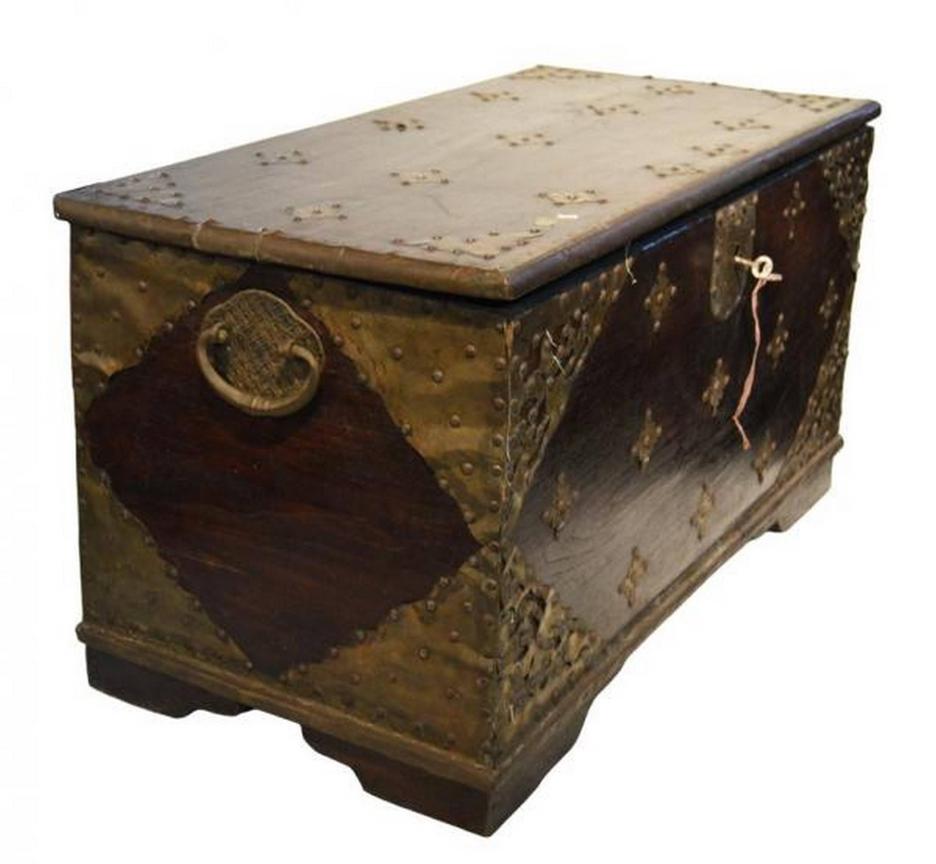 Antique Indonesian Madura chest with original traditional ornate hardware, hinged top, lateral brass handles.