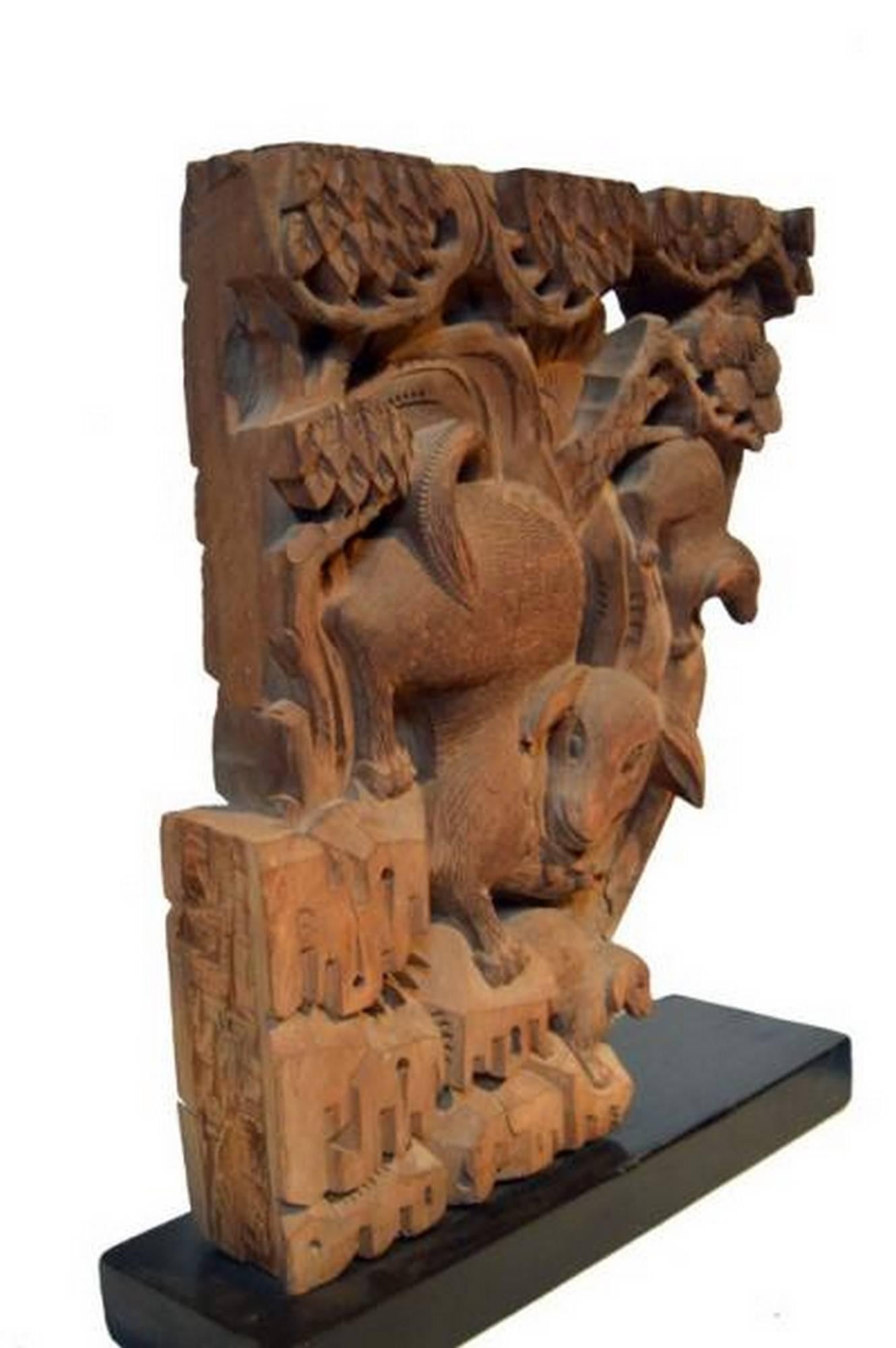 A pair of Chinese 18th century hand-carved wooden temple corbels. Each corbel features detailed animals, shells, and other adornments among openwork foliage patterns. The scenes with these animals take place on stylized rocks and under a tree. The