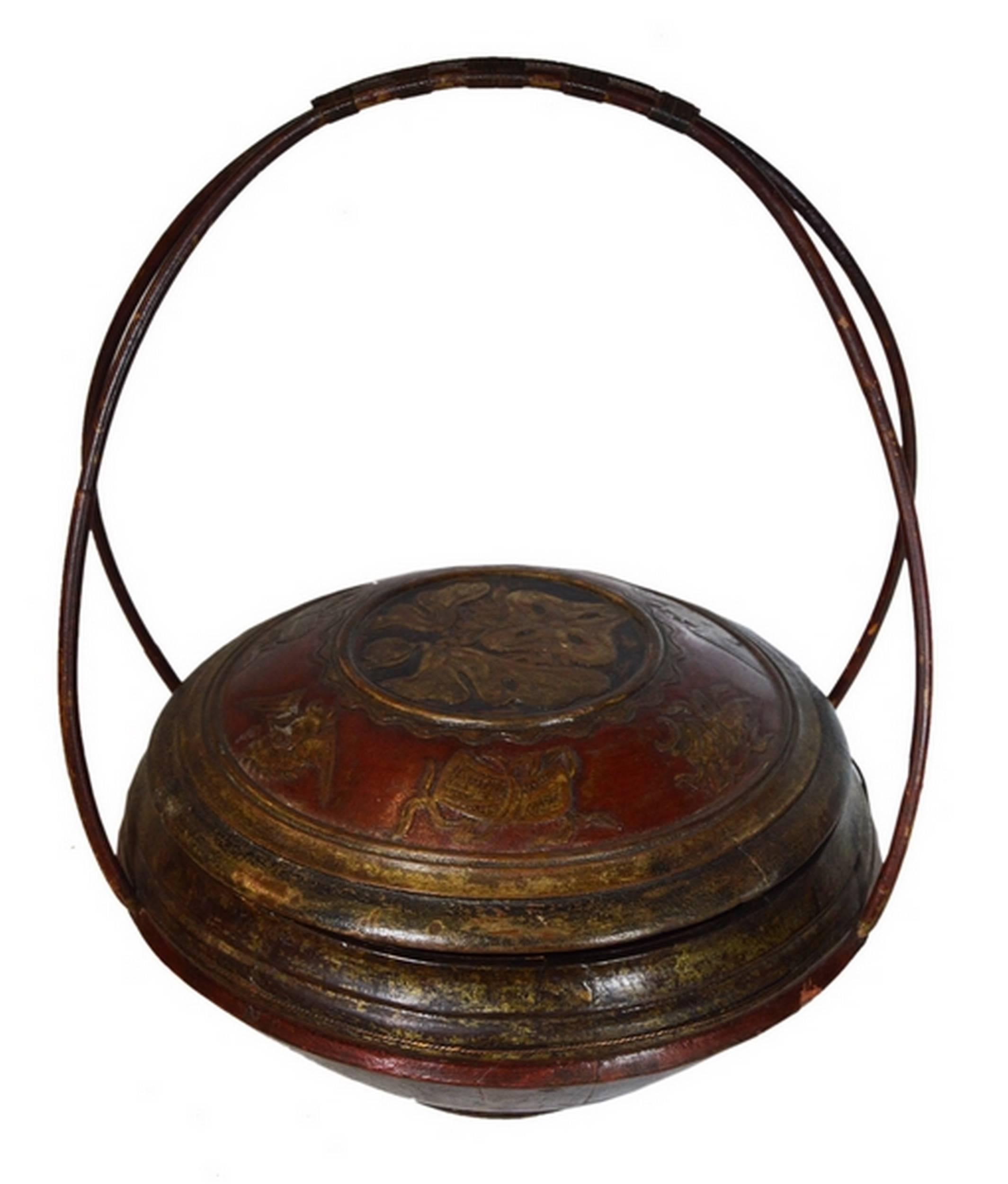 A 19th century Chinese carved wooden grain basket with large handles made of bamboo. This basket is made of a large bowl closed by a lid. The entire varnished basket is carved of wood and painted in red with touches of black. The lid showcases