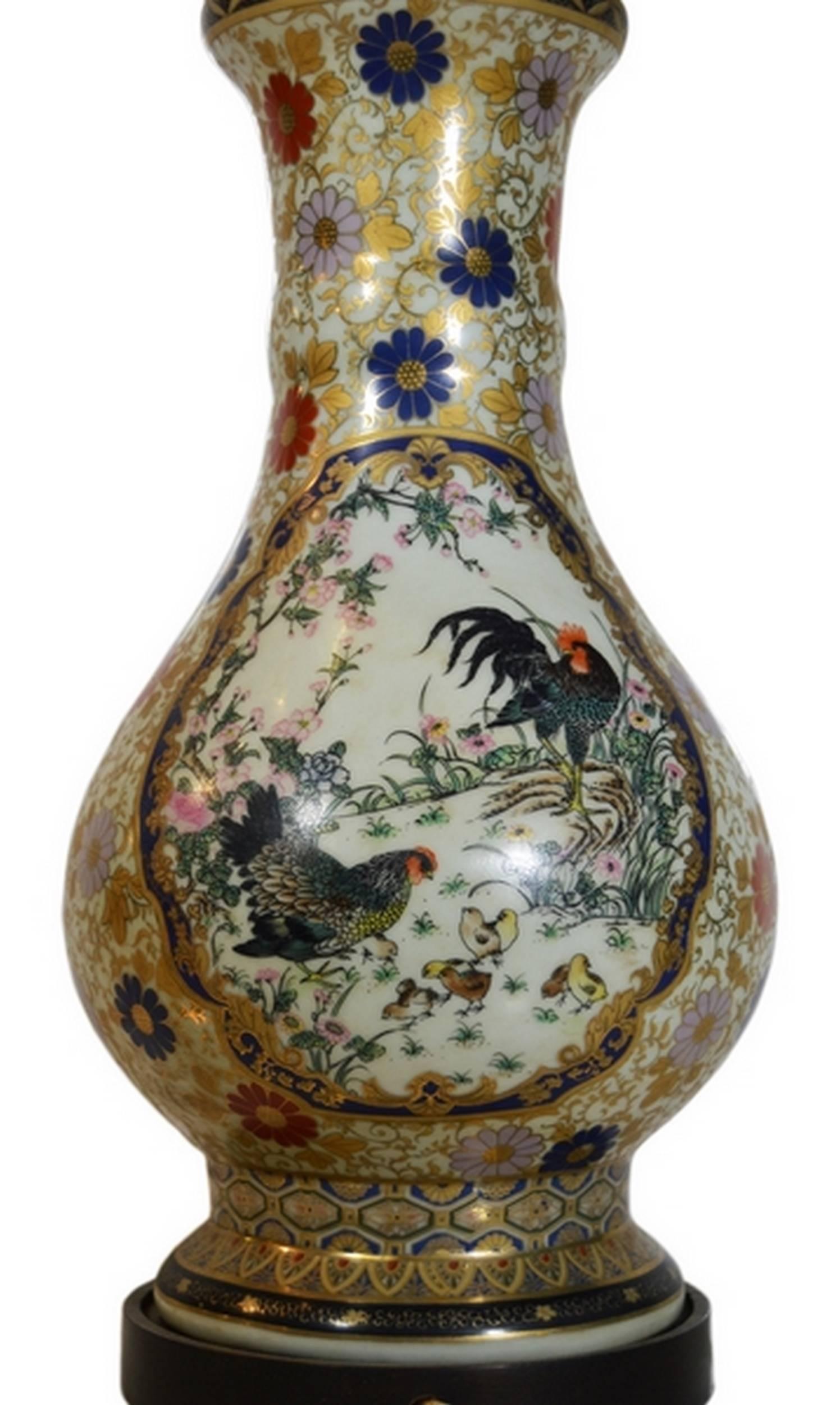 A vintage Chinese tall lamp with hand-painted designs on porcelain. This lamp adopts a classic Chinese vase shape. The lamp is covered by adornments such as golden foliages and blue, red and pink flowers. A blue frame on the belly contains a flower