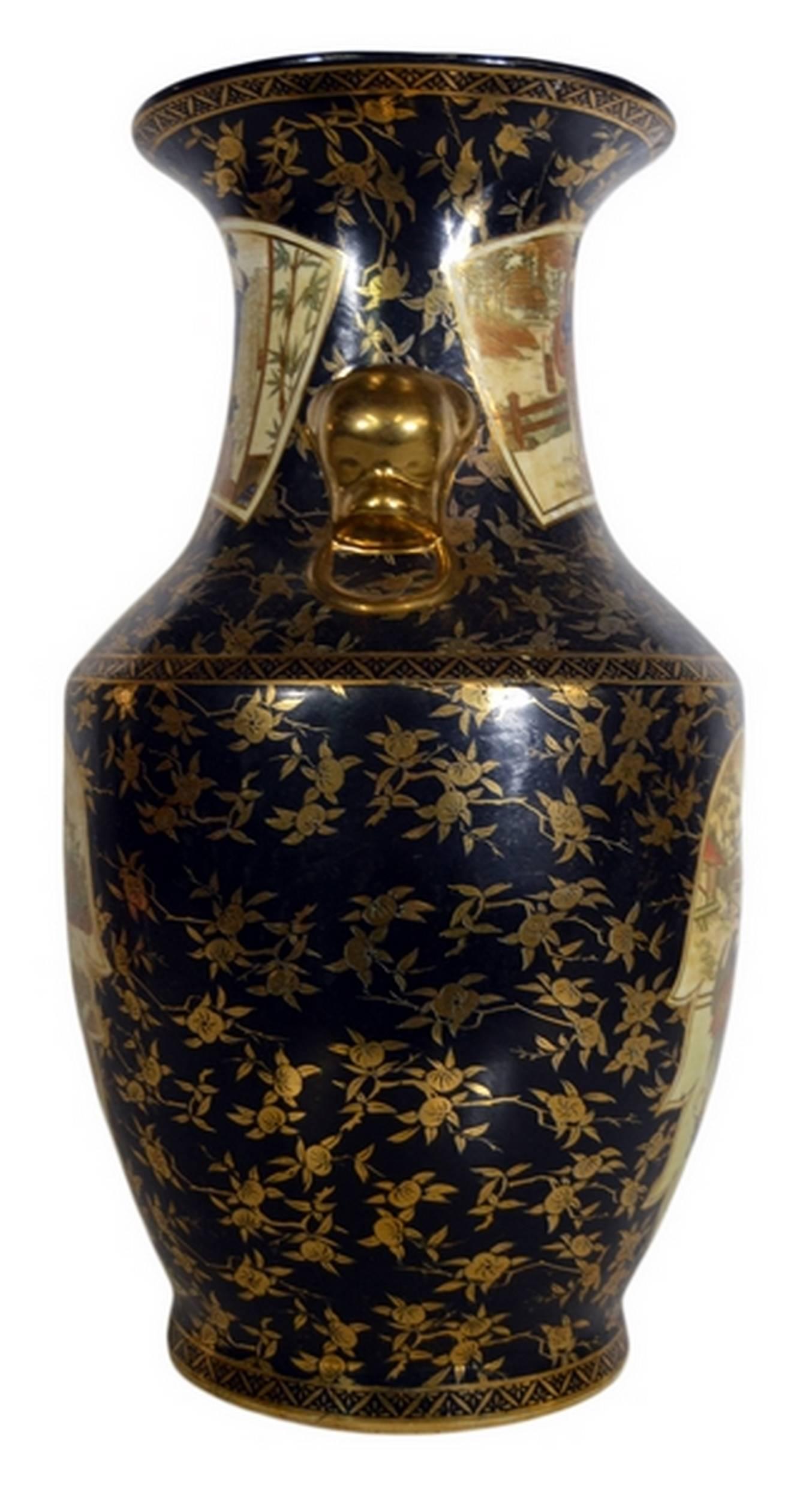 A Chinese vase with scenes and accents hand-painted on porcelain from the late 20th century. This vase adopts a Classic shape with a tall flared neck surrounded by two nose shaped handles with rings. This item displays a black painted background