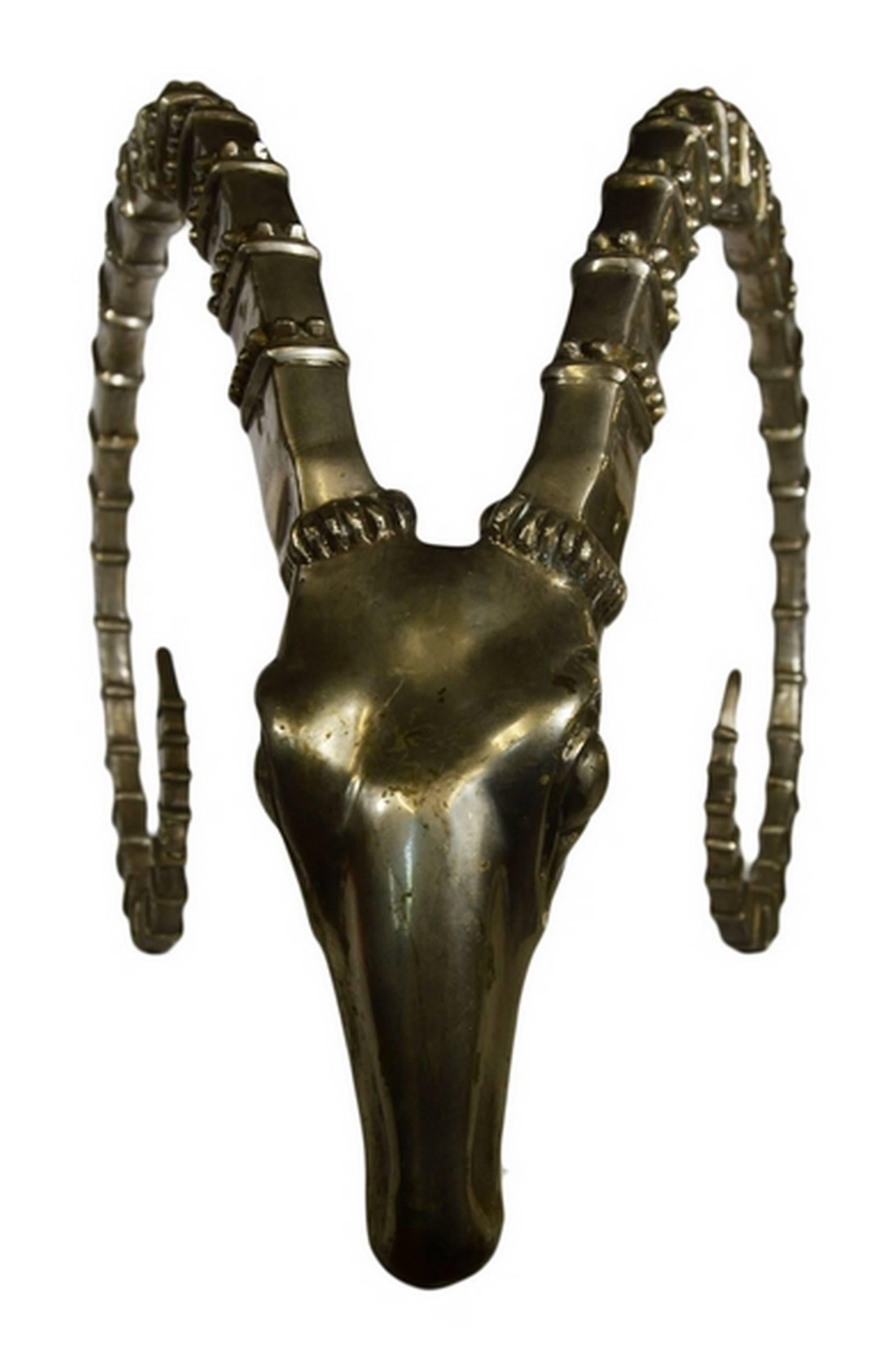 A slender silver plated bronze antelope head sculpture from Thailand, featuring a detailed appearance from the 20th century. This large antelope head features an elegant face with its thin spiral horns. This piece imitates a hunting trophy with a