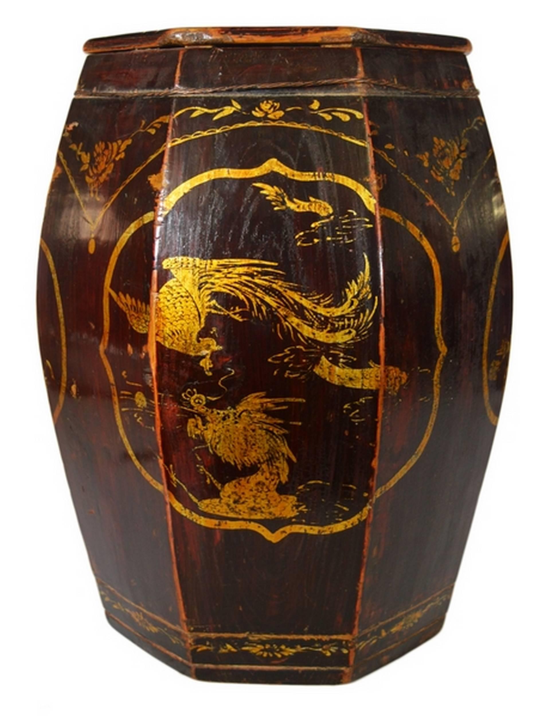 A 19th century grain storage barrel with medallions, hand-painted in, China. This octagonal barrel was made with dark varnished wood and features a belly adorned with three gilt, hand-painted lobed medallions. Two medallions depict a flower and bird