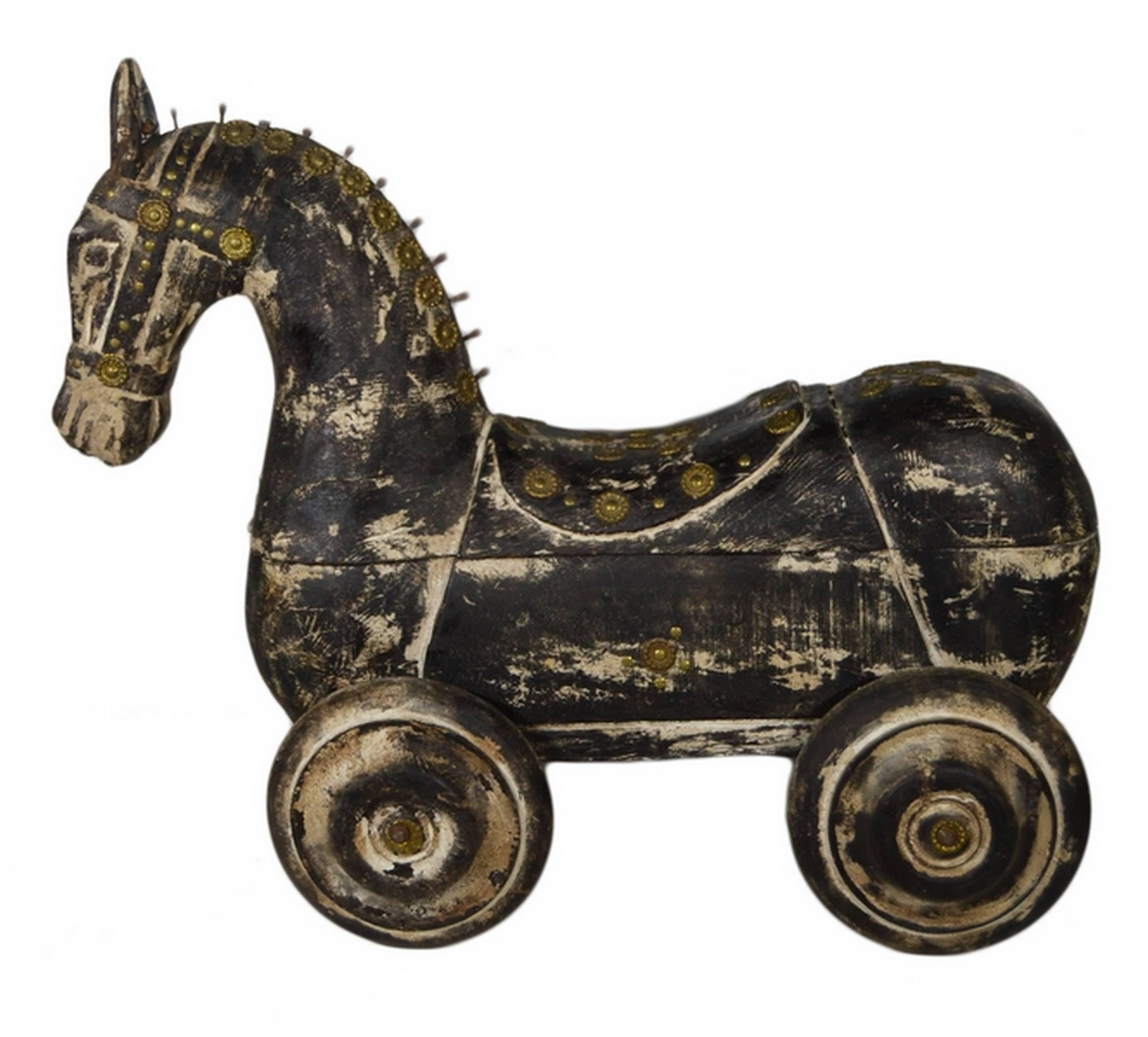 A hand carved wooden horse with wheels and iron features from 20th century India.  This horse showcases a stylized appearance with its unique mane and classic bridle with iron features.  Rather than legs this horse sits on four wheels, and the