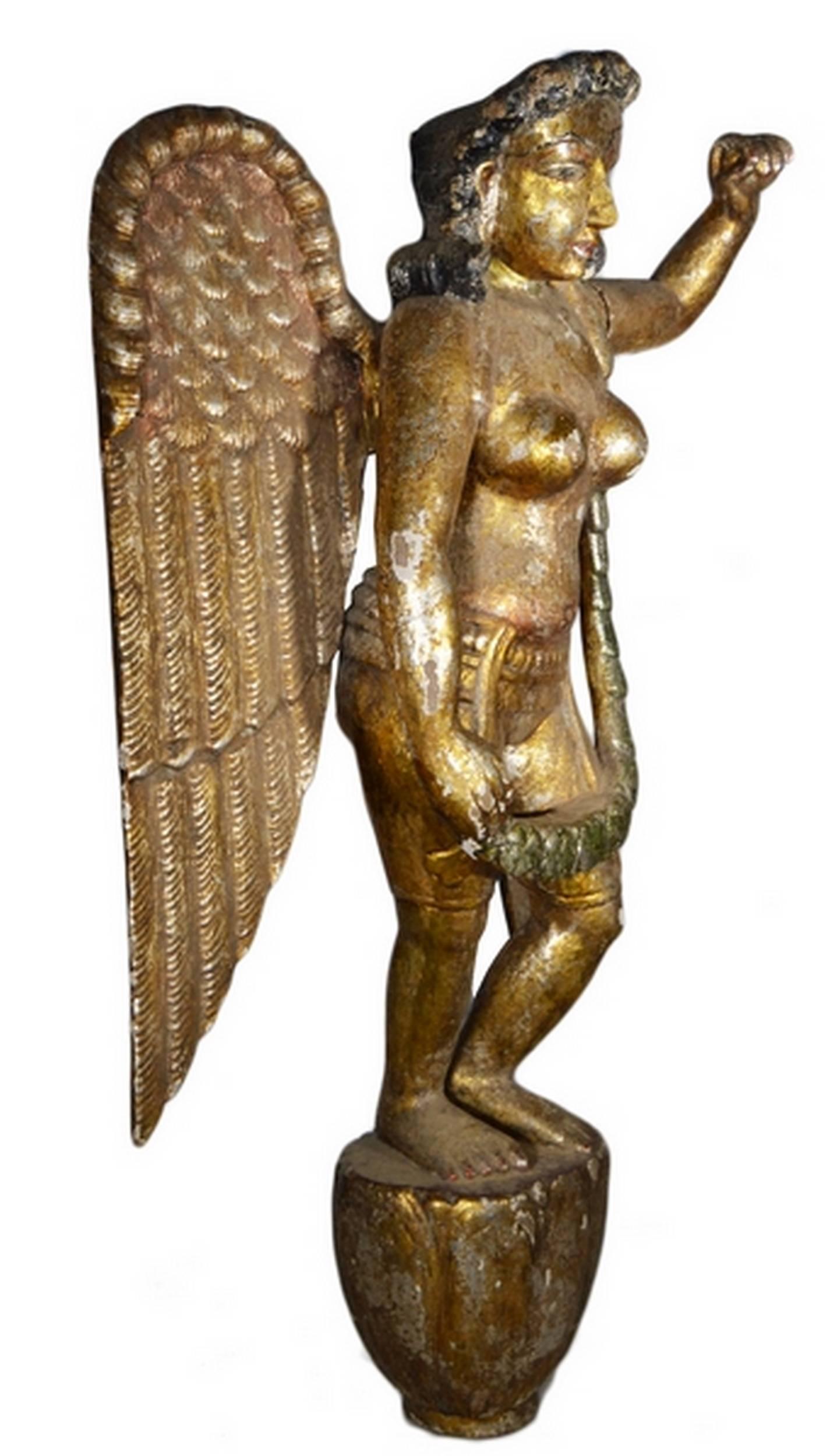 An Asian vintage giltwood hand-carved wooden female angel sculpture from the mid-20th century. This statue features an uncommon combination of the traditional Christian angel symbol and the sensual elegance of Asiatic sculpture, especially from