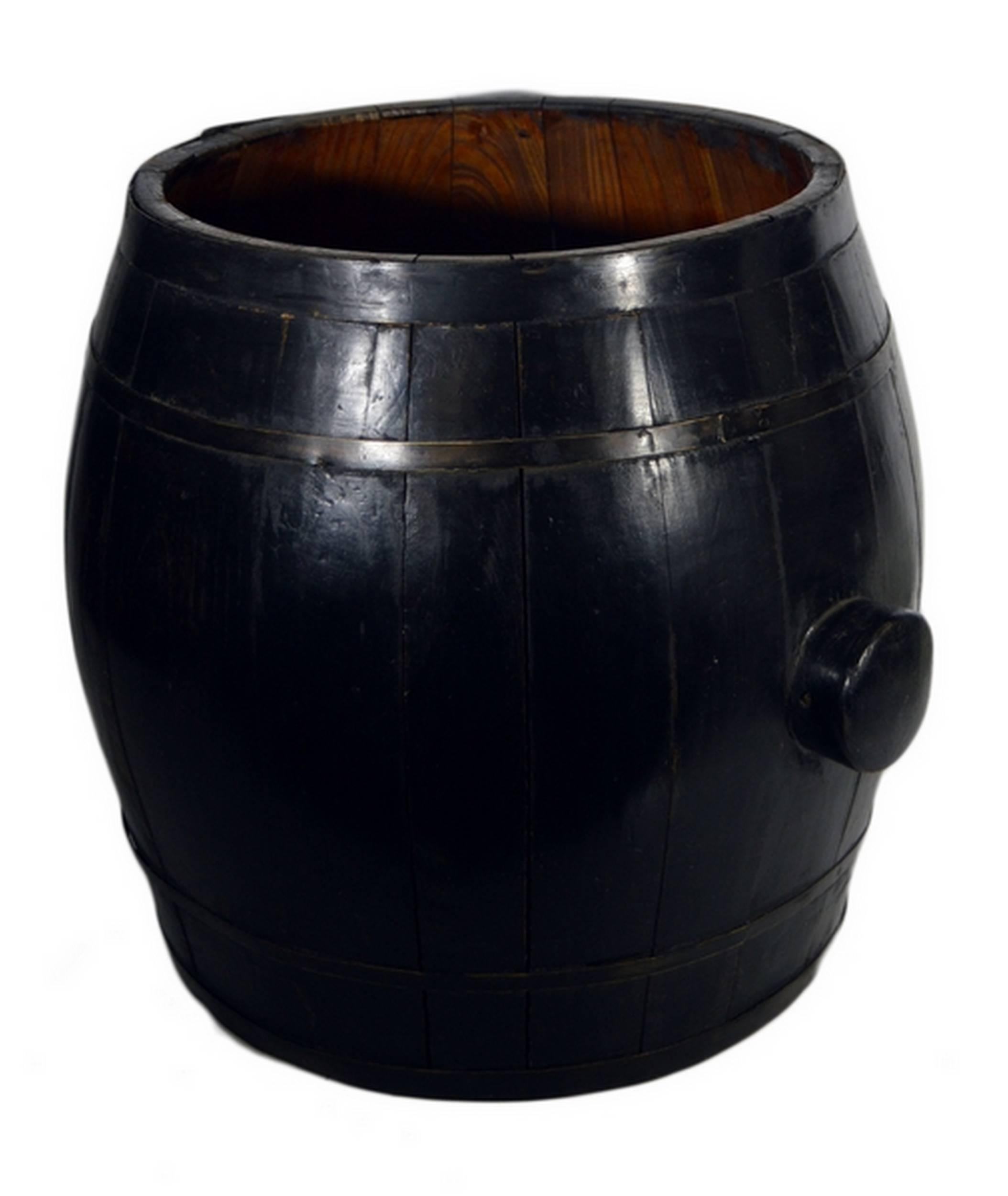 A 19th century Chinese grain barrel handmade with varnished wood. This barrel is made of rounded wood planks reinforced by metallic rings. The sides feature two round handles for lifting. The exterior of this handmade barrel is varnished in a dark