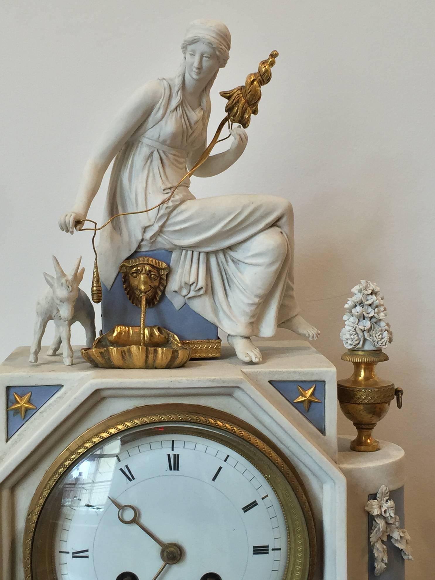 A fine Louis XVI period white and blue porcelain bisque clock, with the figure of a neoclassical woman with a goat and fountain, fine gilt bronze mounts, movement signed by LePautre a Paris, French, late 18th century.
Measures: Width 10 1/2”, depth