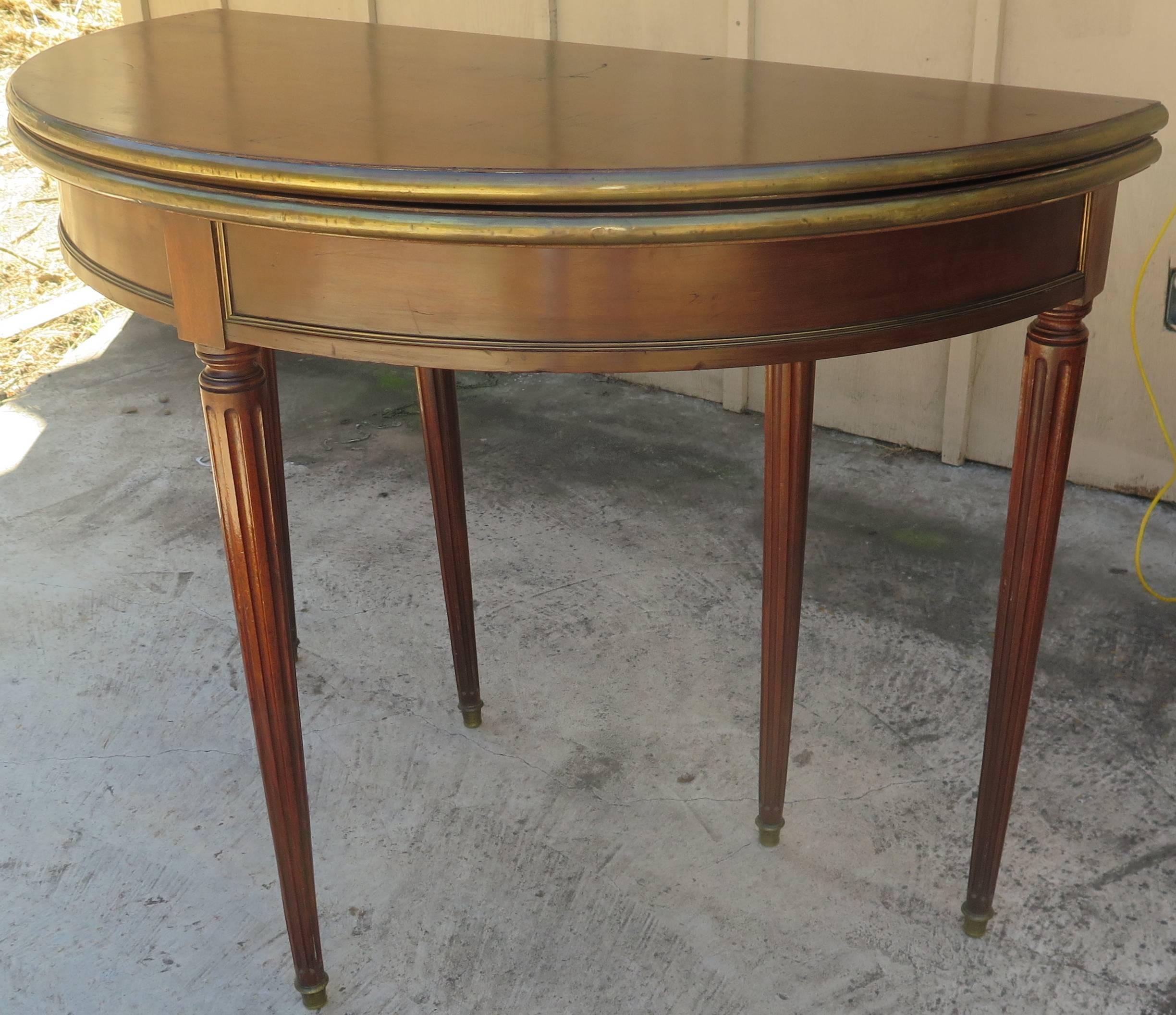 Beautiful French demilune with bronze trim, converts to round game table. Manner of Jansen.
