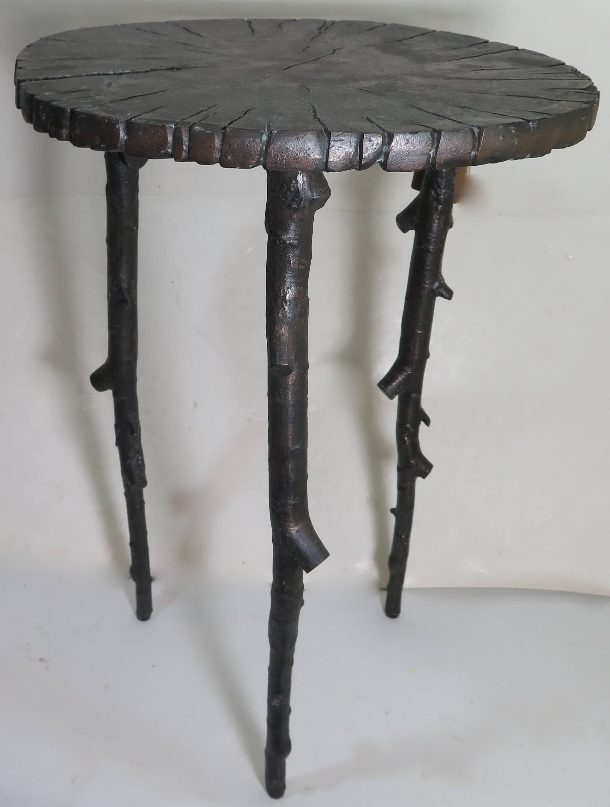 Bronze tree branch side table with three legs.