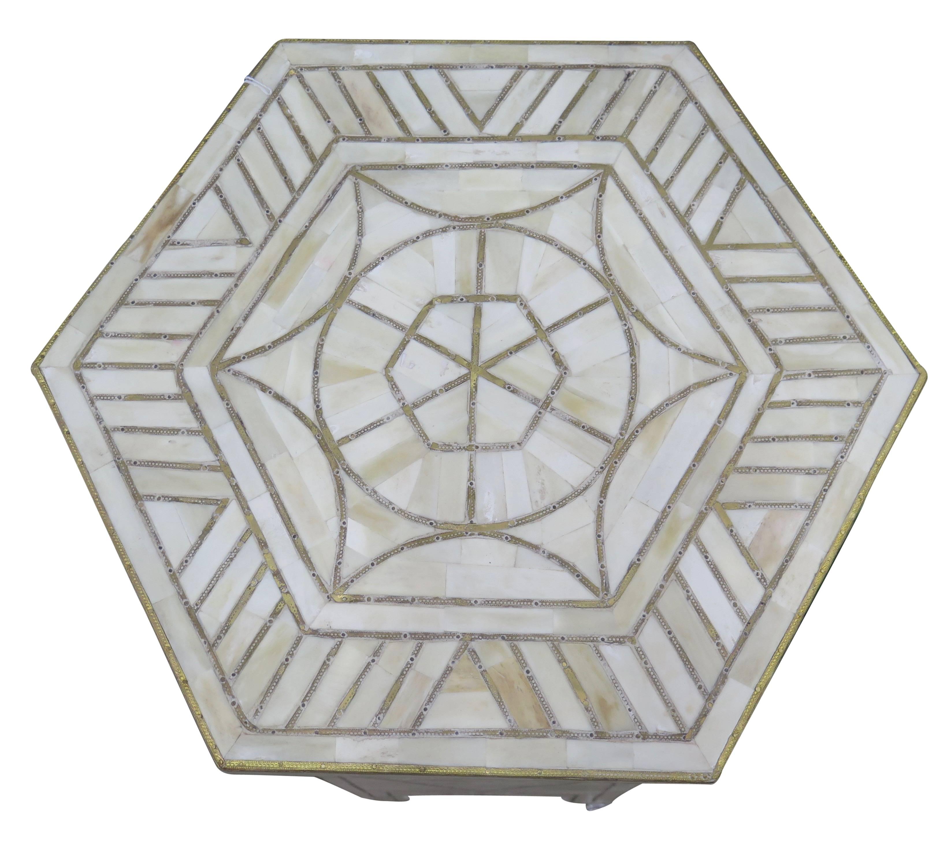 Geometric brass designs on bone inlay.