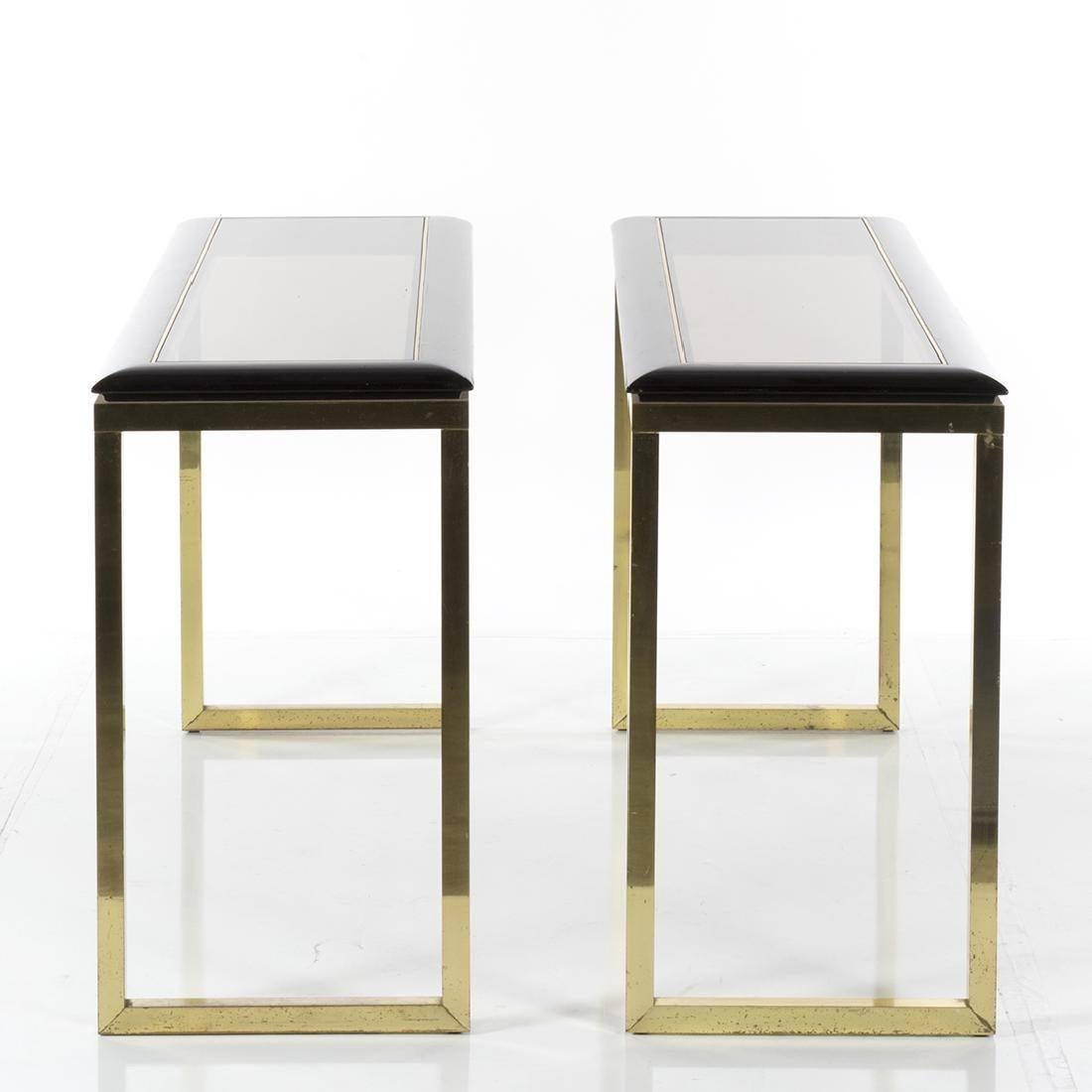Pair of console tables in ebonized oak and brass, 1970s. Measures: 29