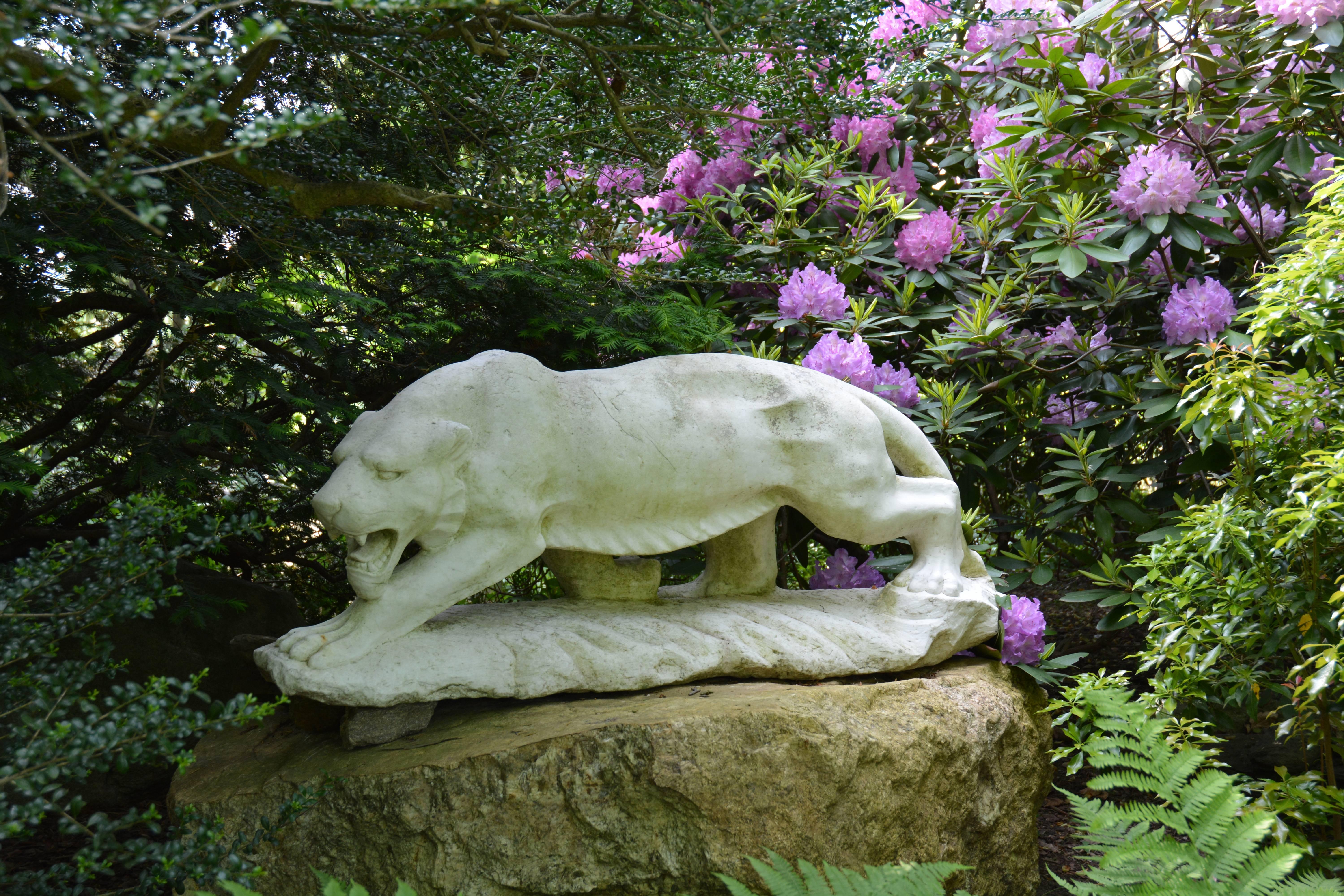 An exceptional Art Moderne carved marble figure of a tiger, captured mid-stride and on the hunt with articulated musculature. Shown on an elevated outcropping this realistic yet stylized predator is a powerful addition to a contemporary property.