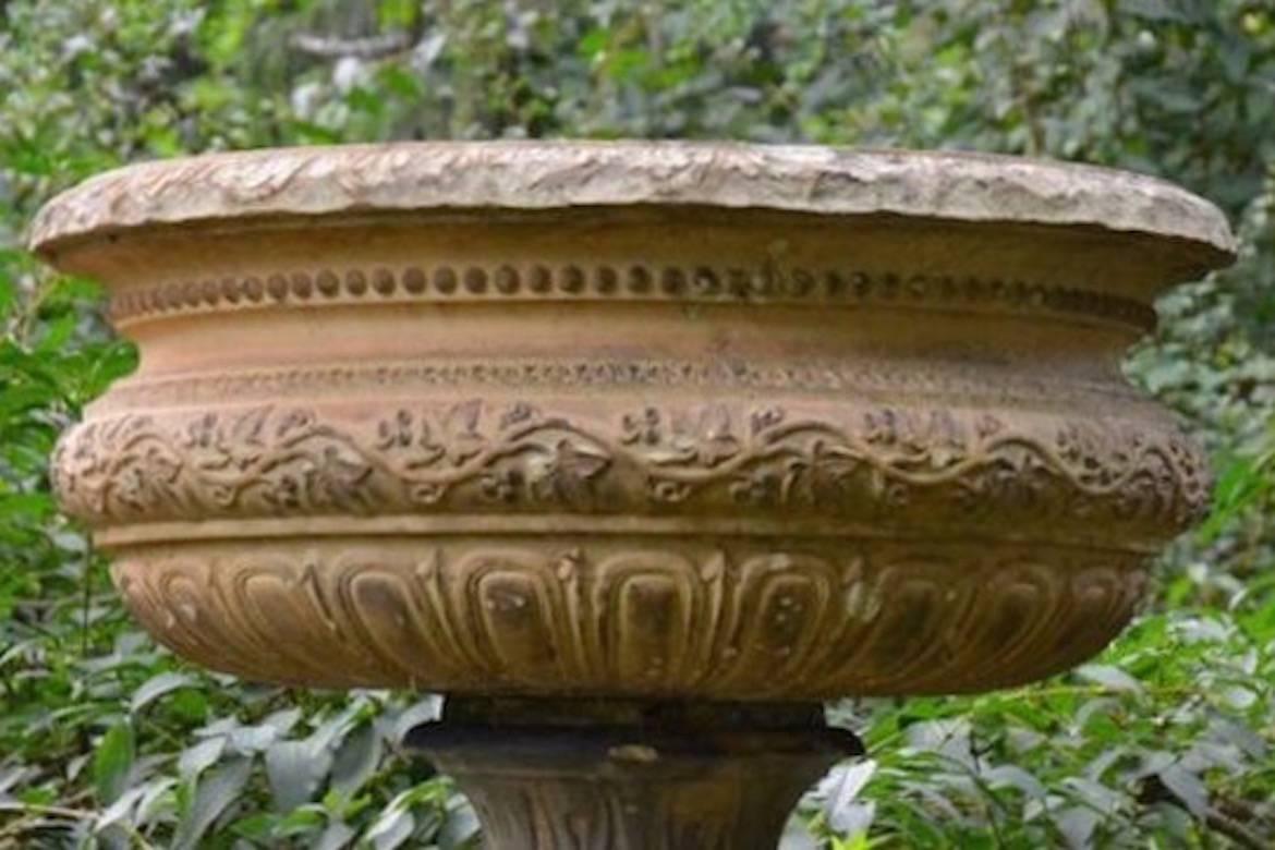 A fine tazza-form stoneware urn marked on inner rim “Doulton & co., Lambeth, London”, the semi-lobed body ornamented with beaded motif and ivy vines, the rising socle with stiff-leaf motif, English, circa 1880, on associated composition stone