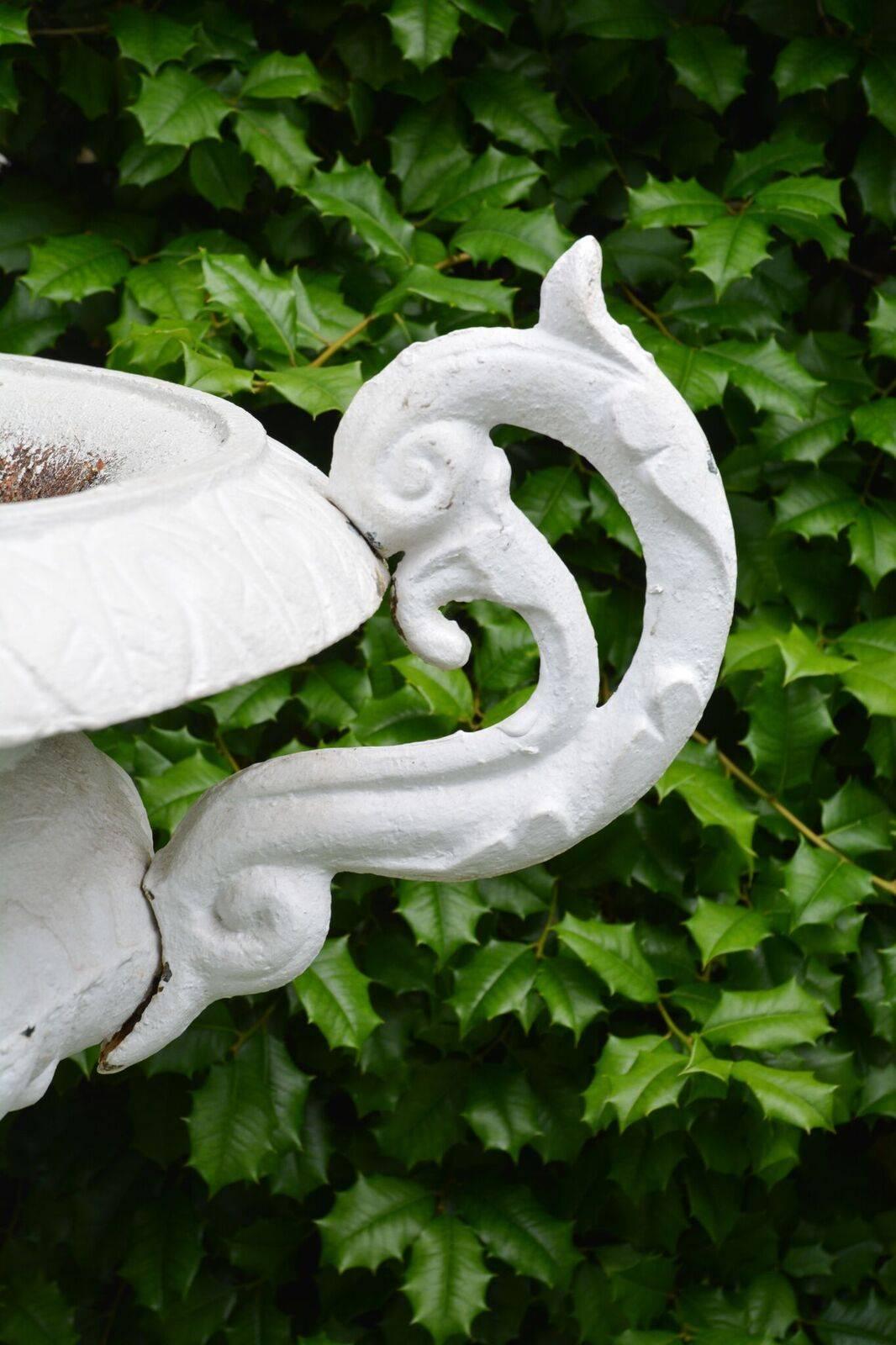 A Pair of White Painted Cast-Iron Urns on Pedestals 1