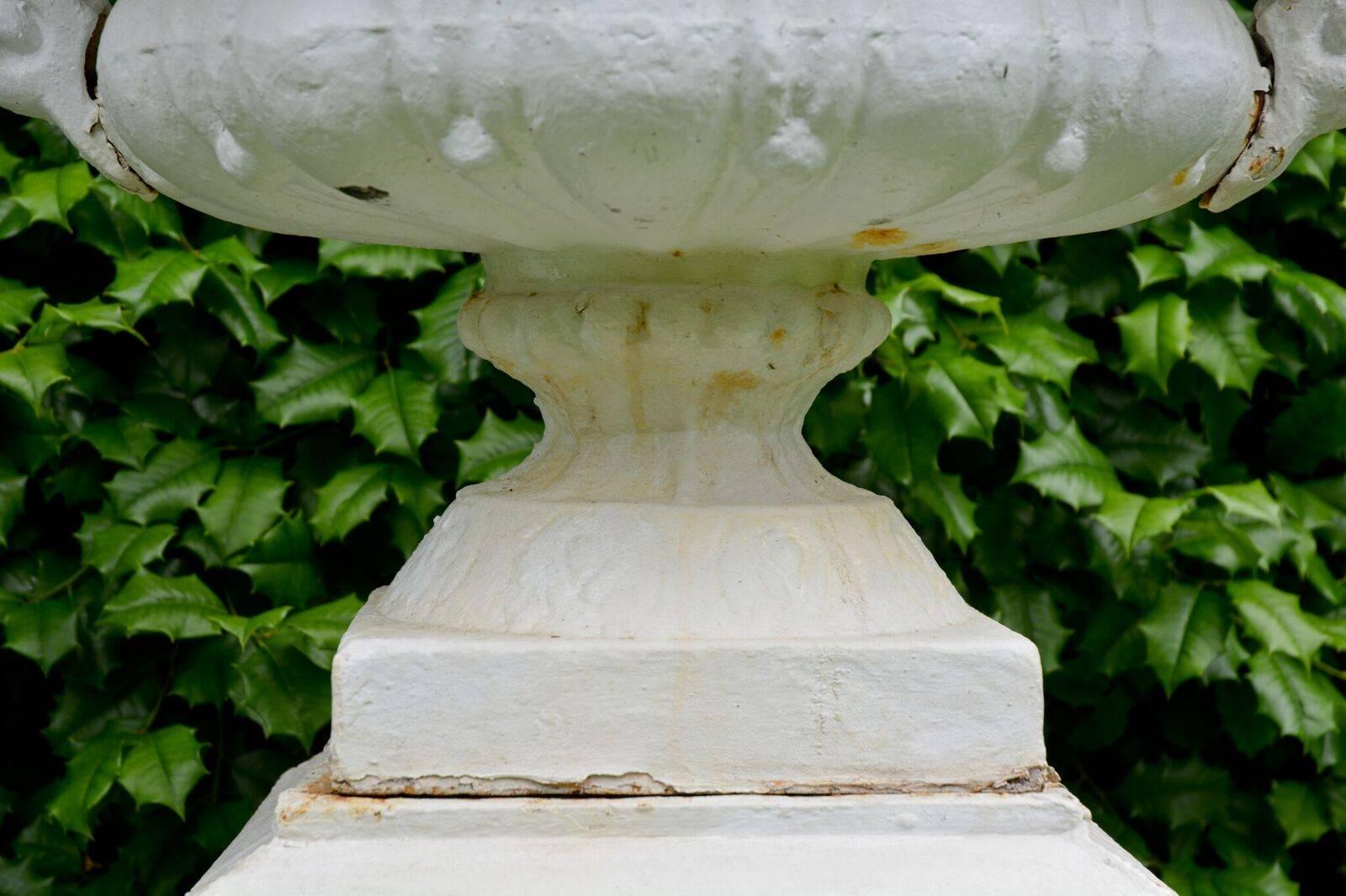 A Pair of White Painted Cast-Iron Urns on Pedestals 2