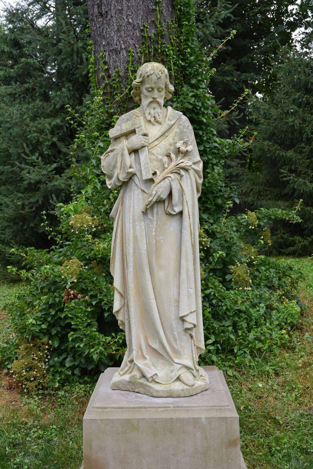 A carved limestone statue of St. Joseph, the patron saint of carpenters, fathers and the afflicted, shown with his attributes of a lily and a carpenter’s square, traces of gilt-edging overall.
