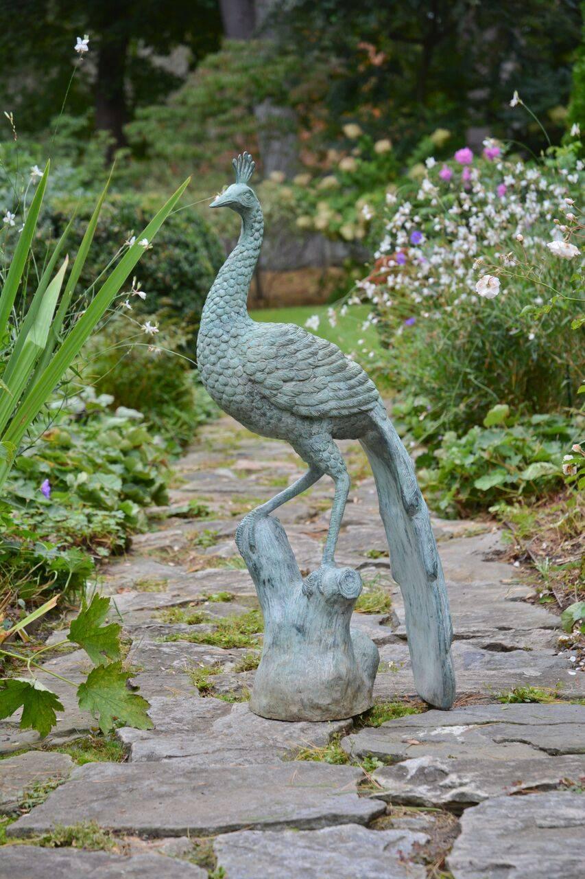 A metal sculpture of a peacock, standing with furled tail, with applied green patina, Indian, contemporary. Measures: 35.8 ins. high.