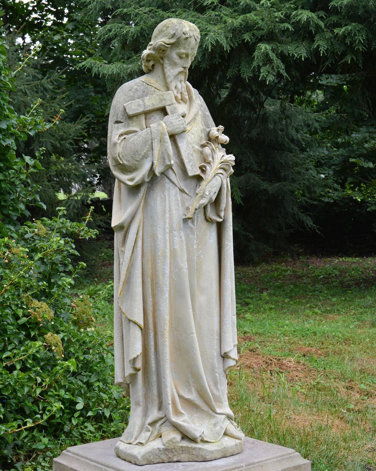 A carved limestone statue of St. Joseph, the patron saint of carpenters, fathers, and the afflicted, shown with his attributes of a lily and a carpenter’s square, traces of gilt-edging overall, English, circa 1890. Measures: 61.5 ins. high, 20 ins.