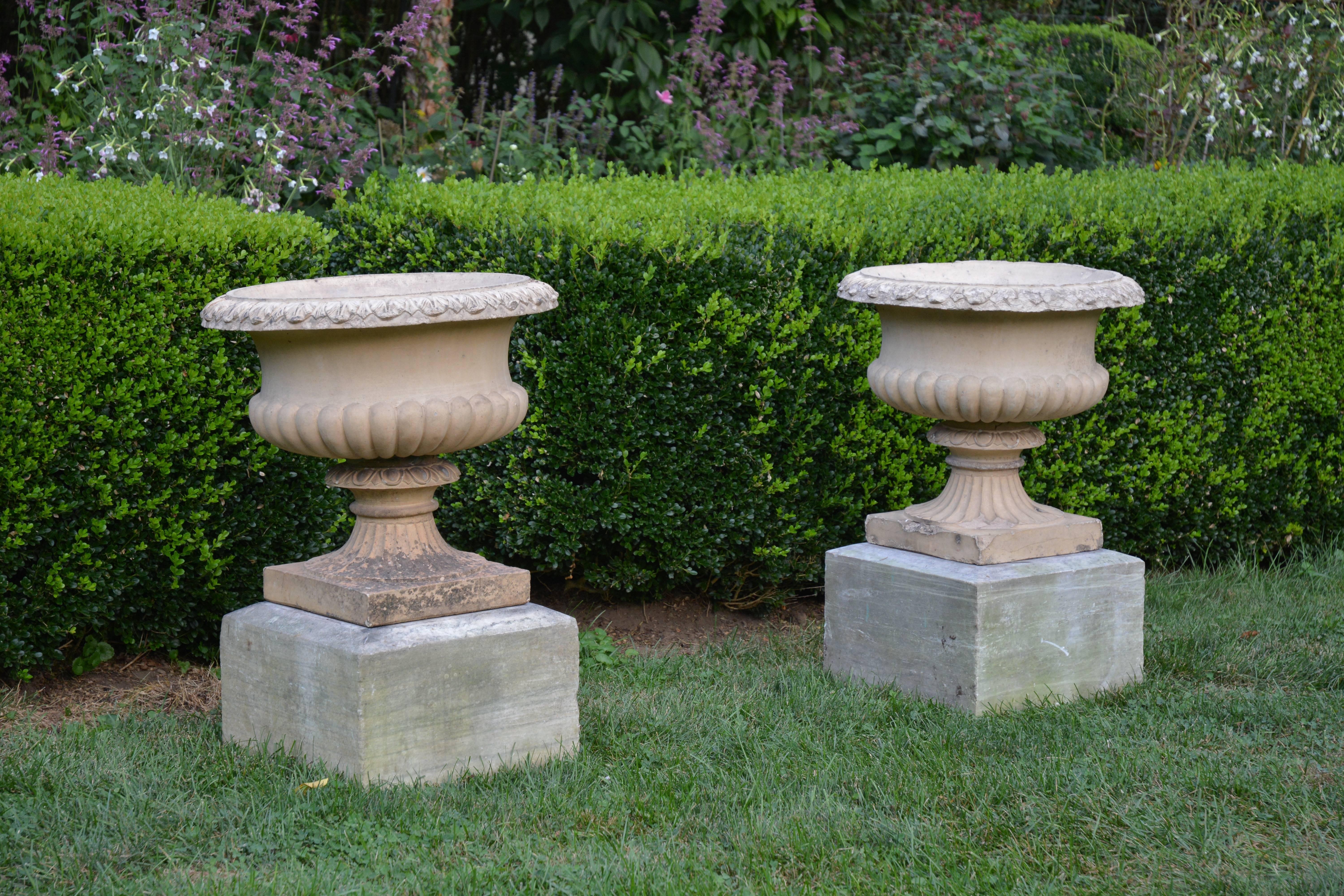 A pair of Royal Doulton-style stoneware tazza-form urns with semi-lobed body and modified egg and dart molding on rim.