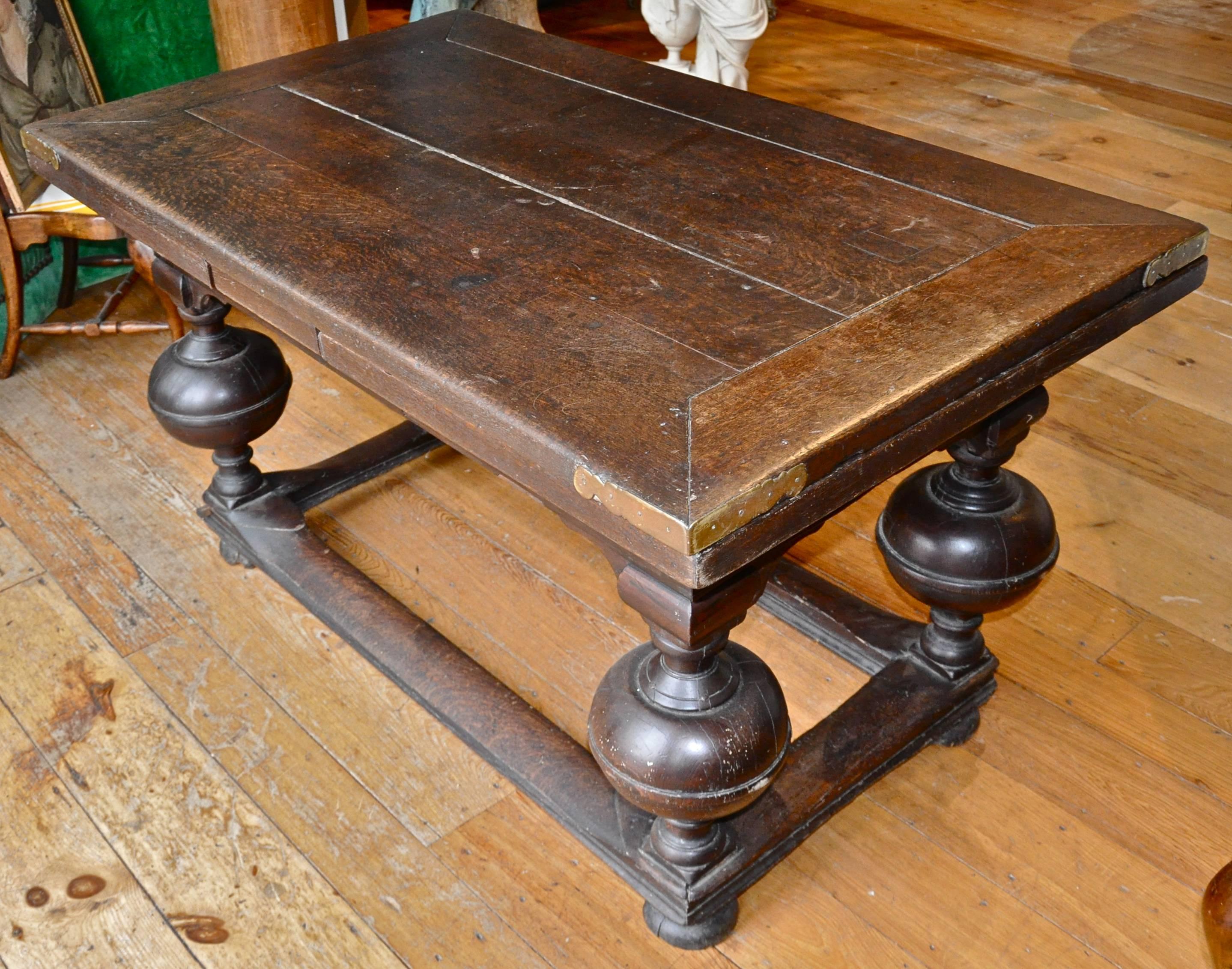 Period Dutch oak Baroque withdraw table.

Four amazingly robust turned ball legs holding original top.
Two leaves withdraw to extend table for dining.
All original.