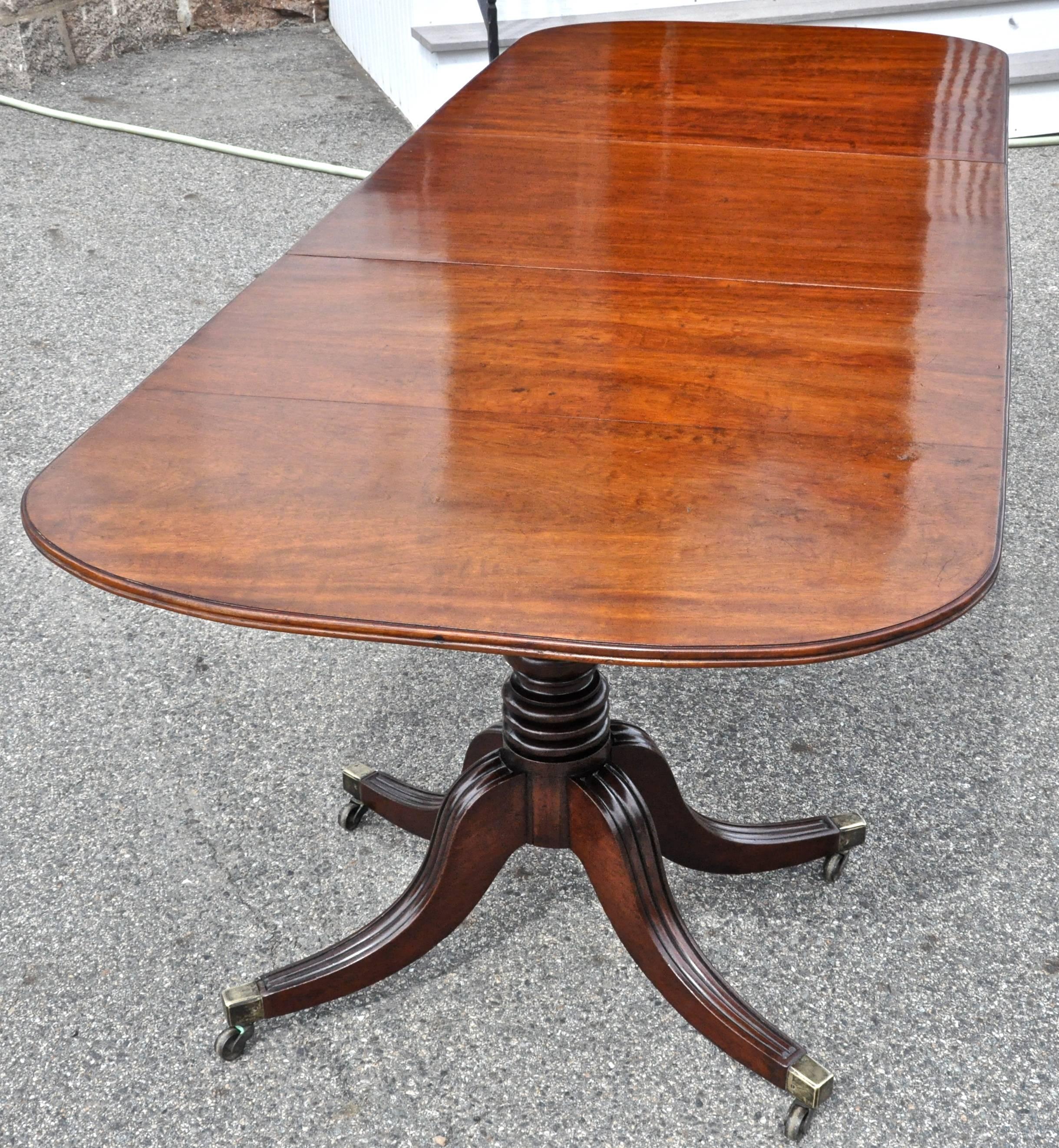 Period early 19th century two pedestal dining table of original narrow width.

Well-turned original pedestals.
Original boards.
Beautiful Cuban plum pudding mahogany throughout.
Original casters.
We are saying English in origin, but could