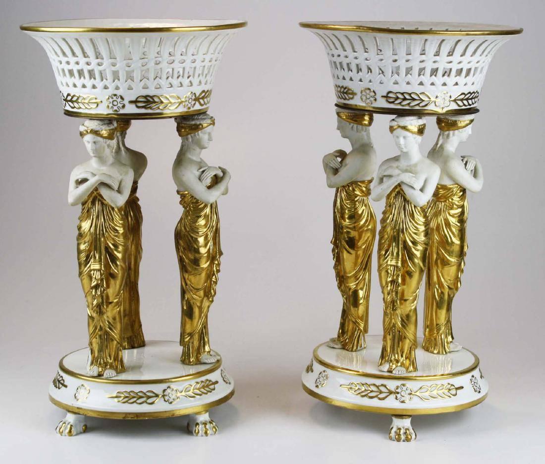 19th century pair of gilt and bisque porcelain Empire centrepieces

Of Sevres form though Old Paris porcelain
Each with three neoclassical female caryatids
Reticulated baskets
Marked 