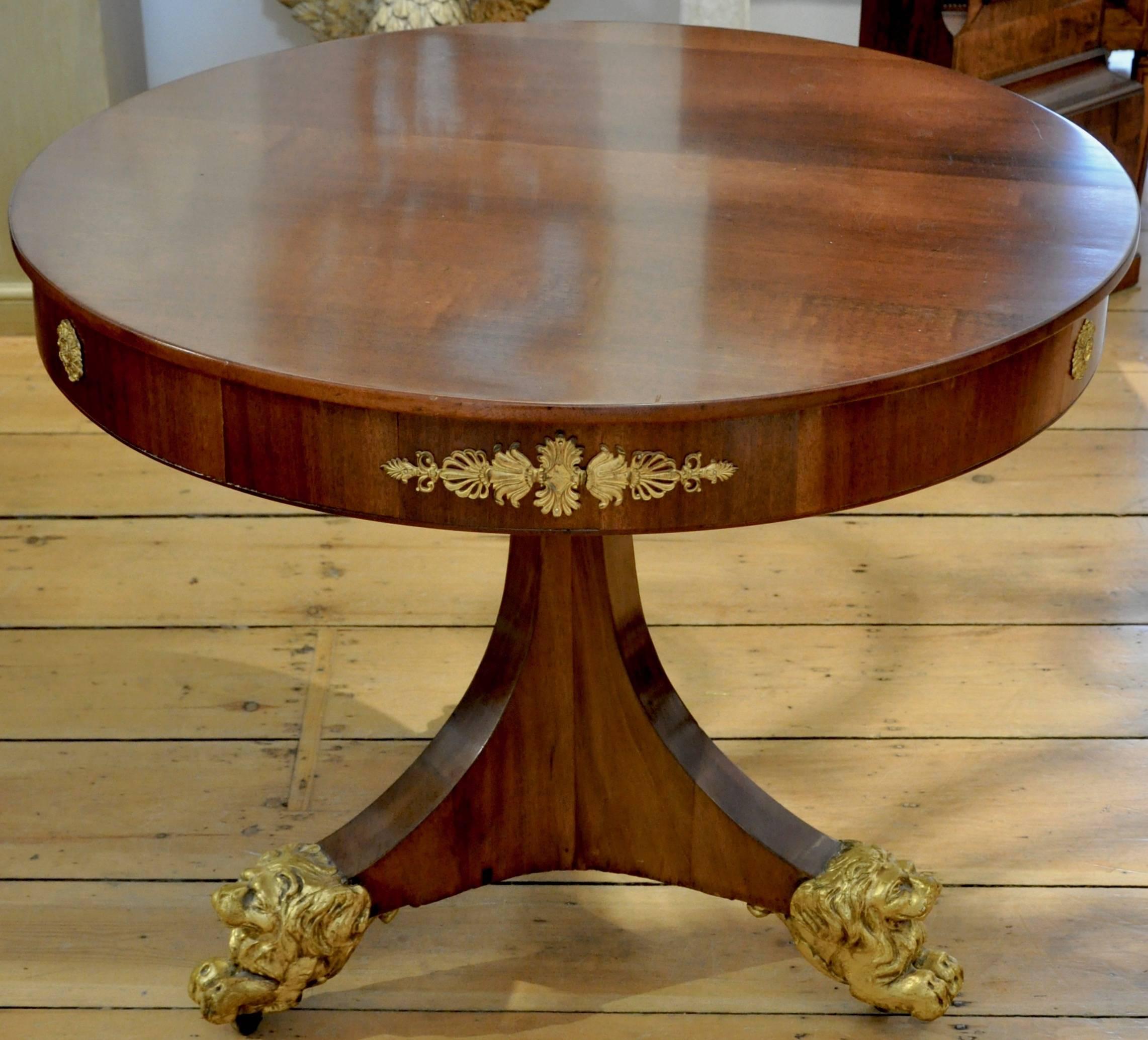 19th century Neoclassical Mahogany center table

--Northern Continental or Danish
--Ormolu mounts and gilt carved wood lion feet
--Great size.