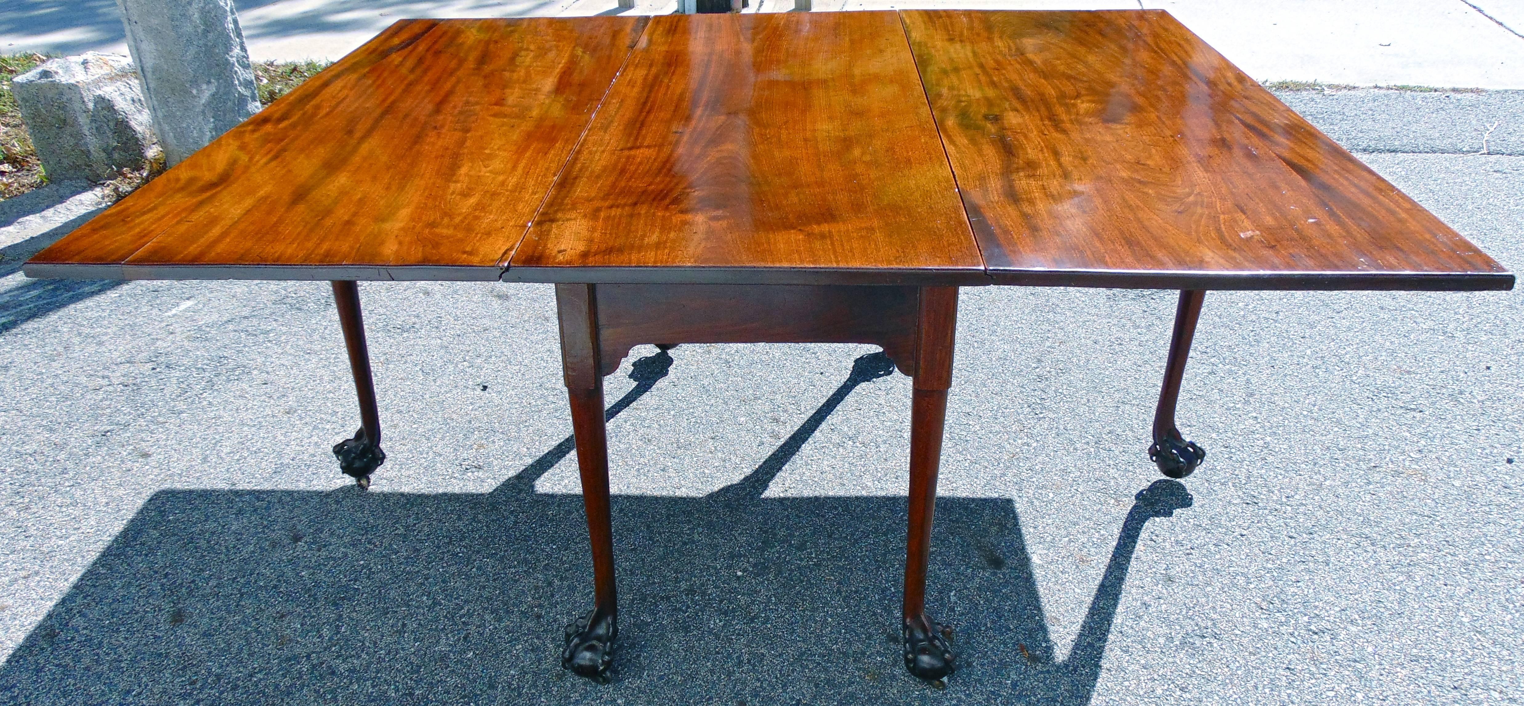 Beautifully constructed and period Georgian Chippendale drop-leaf table.

Rare reticulated claw and ball feet.
Original secondary supports which fold out in locking mechanism creating
a fully symmetrical structure.
More than ample size to fit