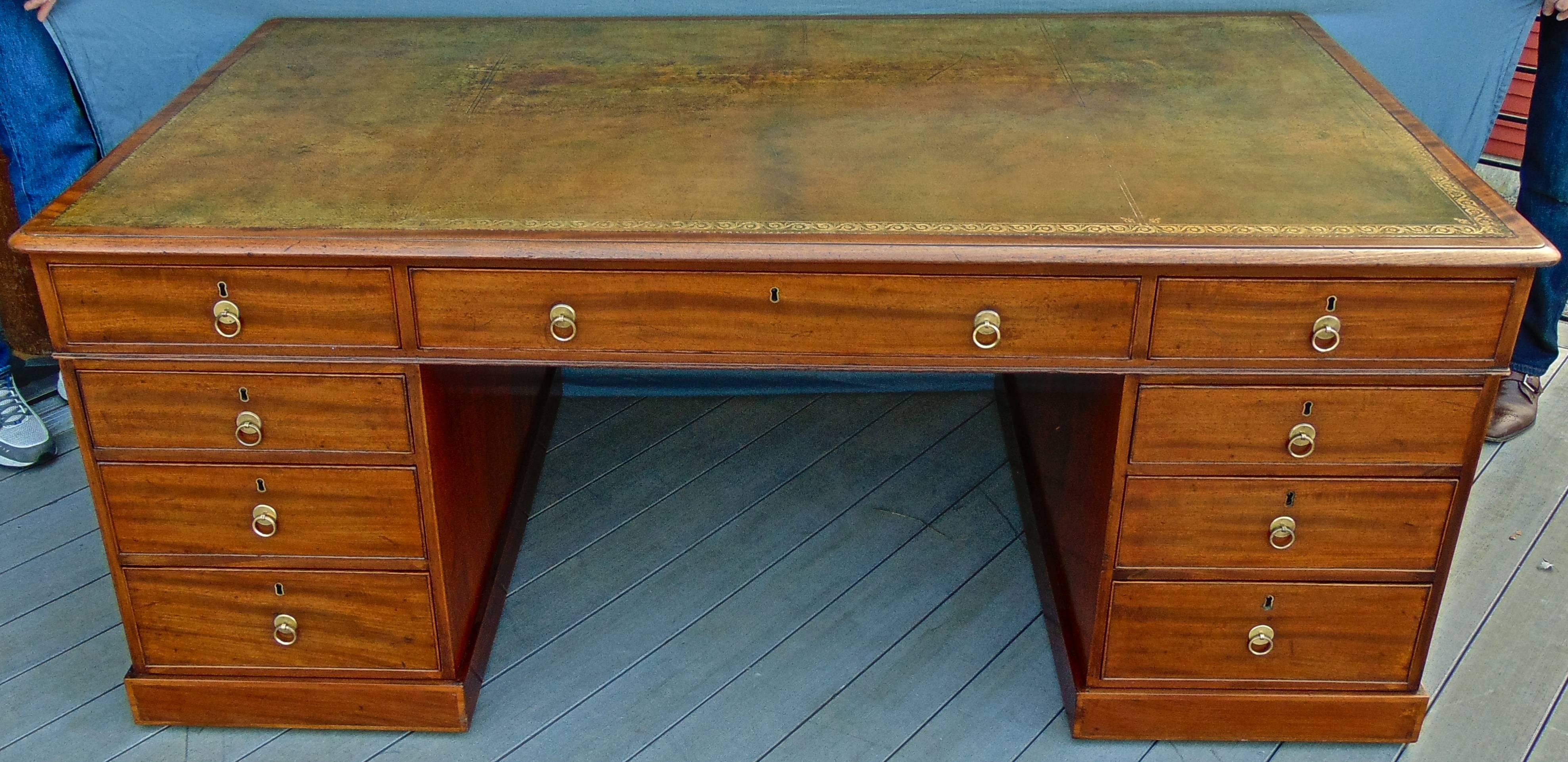Period Georgian true partner desk.

Mahogany.
Green tooled leather top, Melli hues and patina.
Drawers on one side of base/cabinets on reverse.