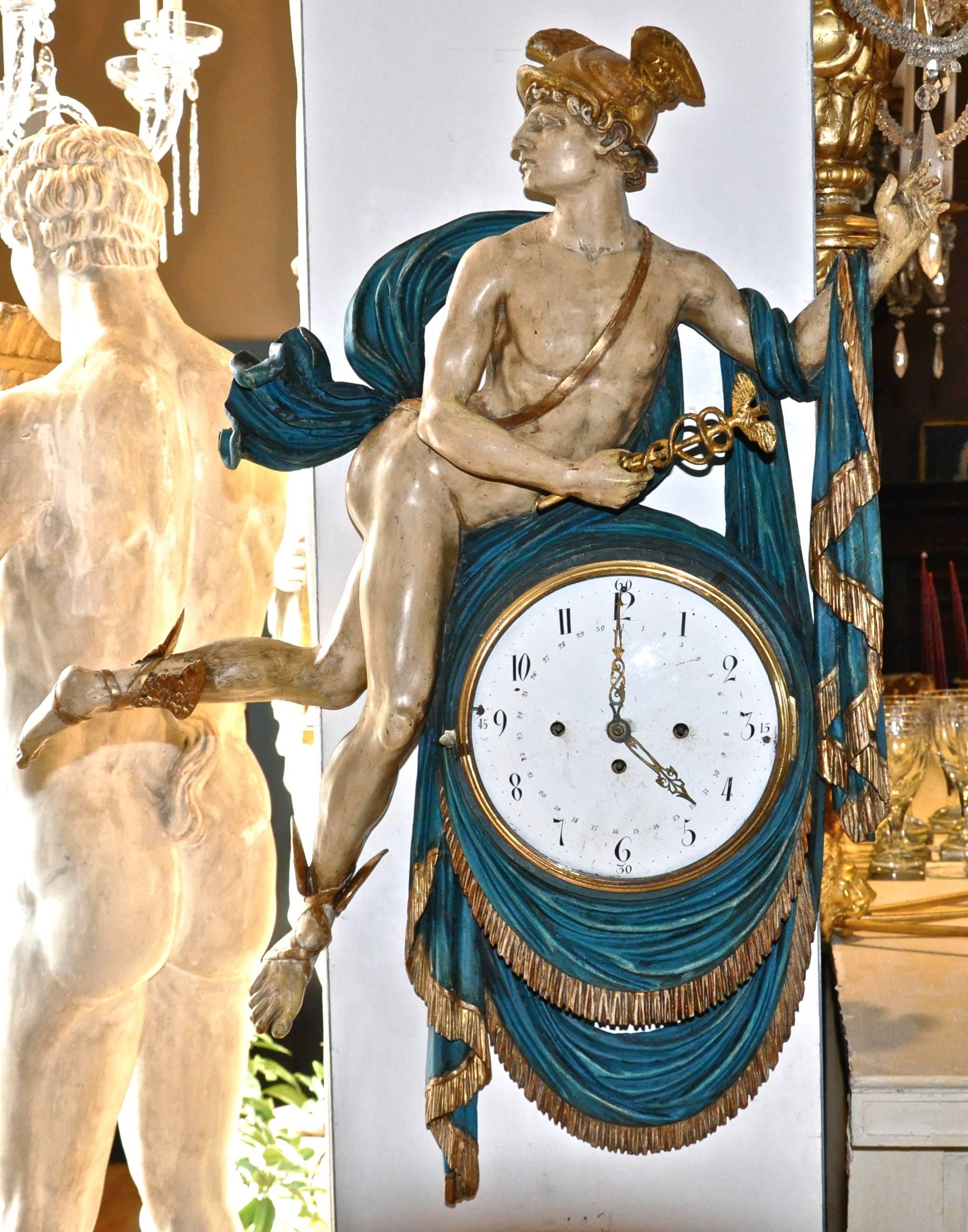 Rare and complete Austrian early 19th century wall clock in form of the god mercury.

Carved, parcel gilt.
Original works to clock.
Exquisitely rendered.
Paint original as well as is gilding.

Mercury is the patron god of financial gain,