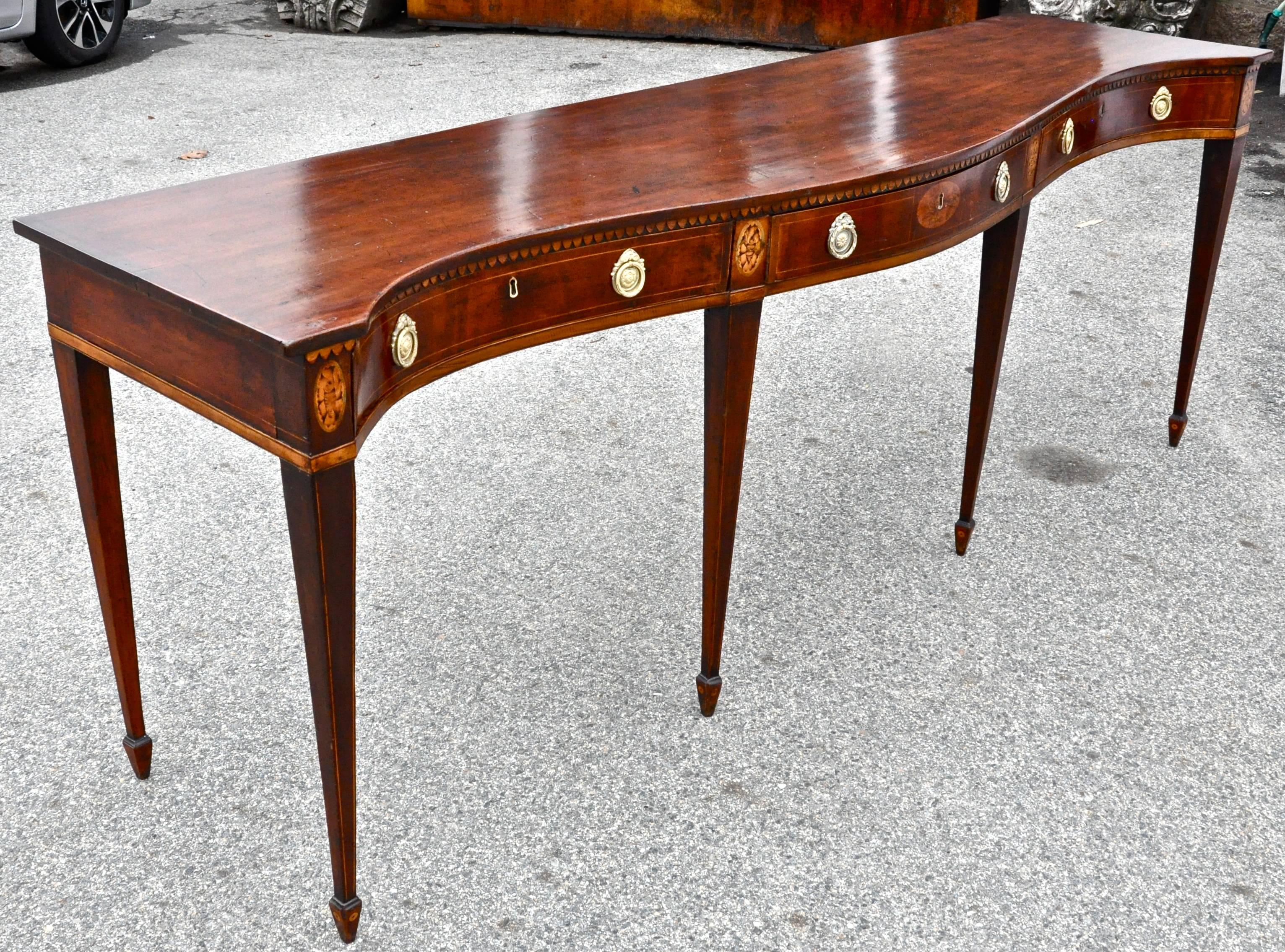 George III mahogany serpentine serving table or sideboard, period late 18th century

Double serpentine form, wonderful shallow depth, Original shell and foliate inlays, original and unusual inlaid spade feet, great patina (not skinned), very early