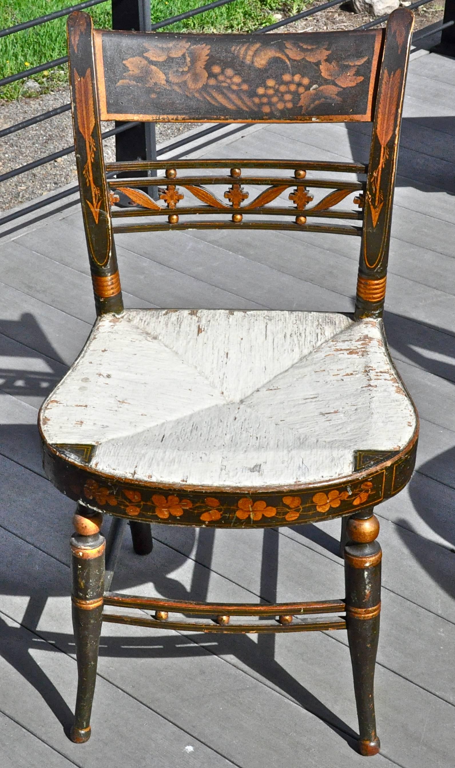 Set of 12 new England fancy painted sheraton dining chairs, Maple, early 19th century.

Original green paint, stenciling and color, original varnish.
Shell and leaf gilt stencil on back, neoclassical arrows on back rails, oak leaves and acorn
