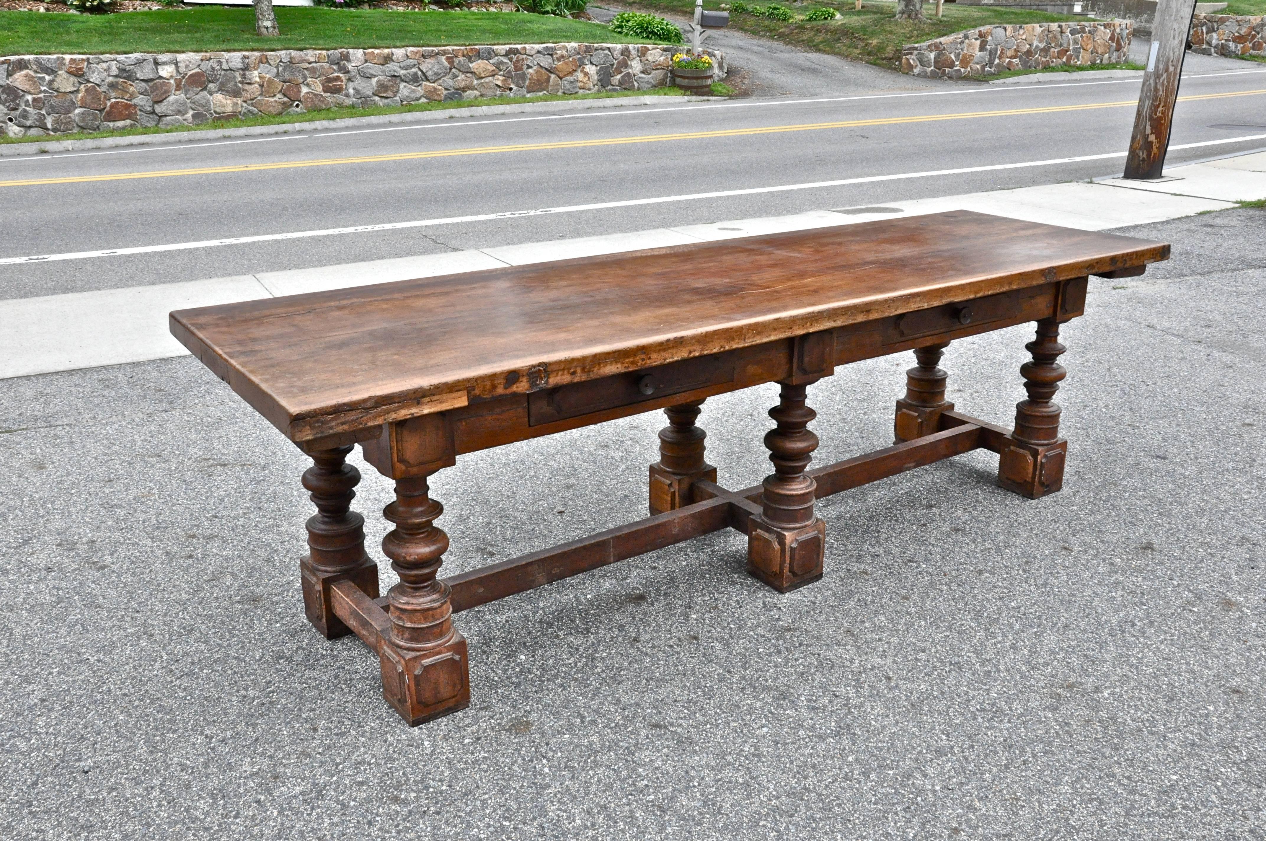 Beautiful Italian walnut refectory table of the 18th century.

Turned walnut legs, two drawers on one side, original stretchers, two board top.
Original dry finish to base
minor restorations
stabile and sound.
Florentine, early 18th century.