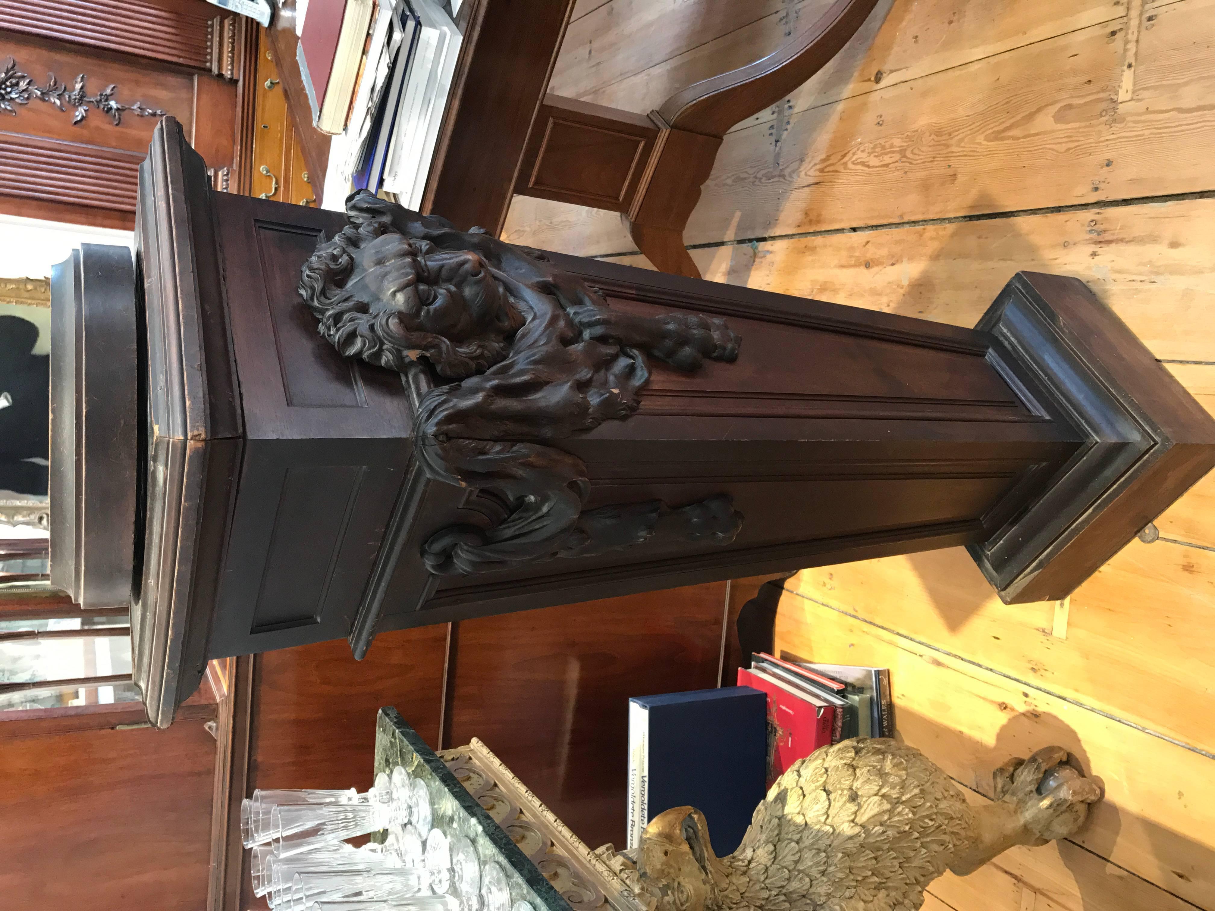 19th Century Walnut Pedestal

Victorian Tapered Paneled Form.  Carved Walnut Skin of the Nemean Lion Draped on three sides.  Top turns to move sculpture