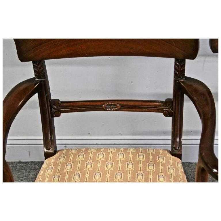 Set of 12 Regency style chairs in mahogany

--Ten sides and two armchairs
--Upholstered seats
--Beautiful shaped back in Cuban mahogany
--Tapered front legs and Klismos form back.