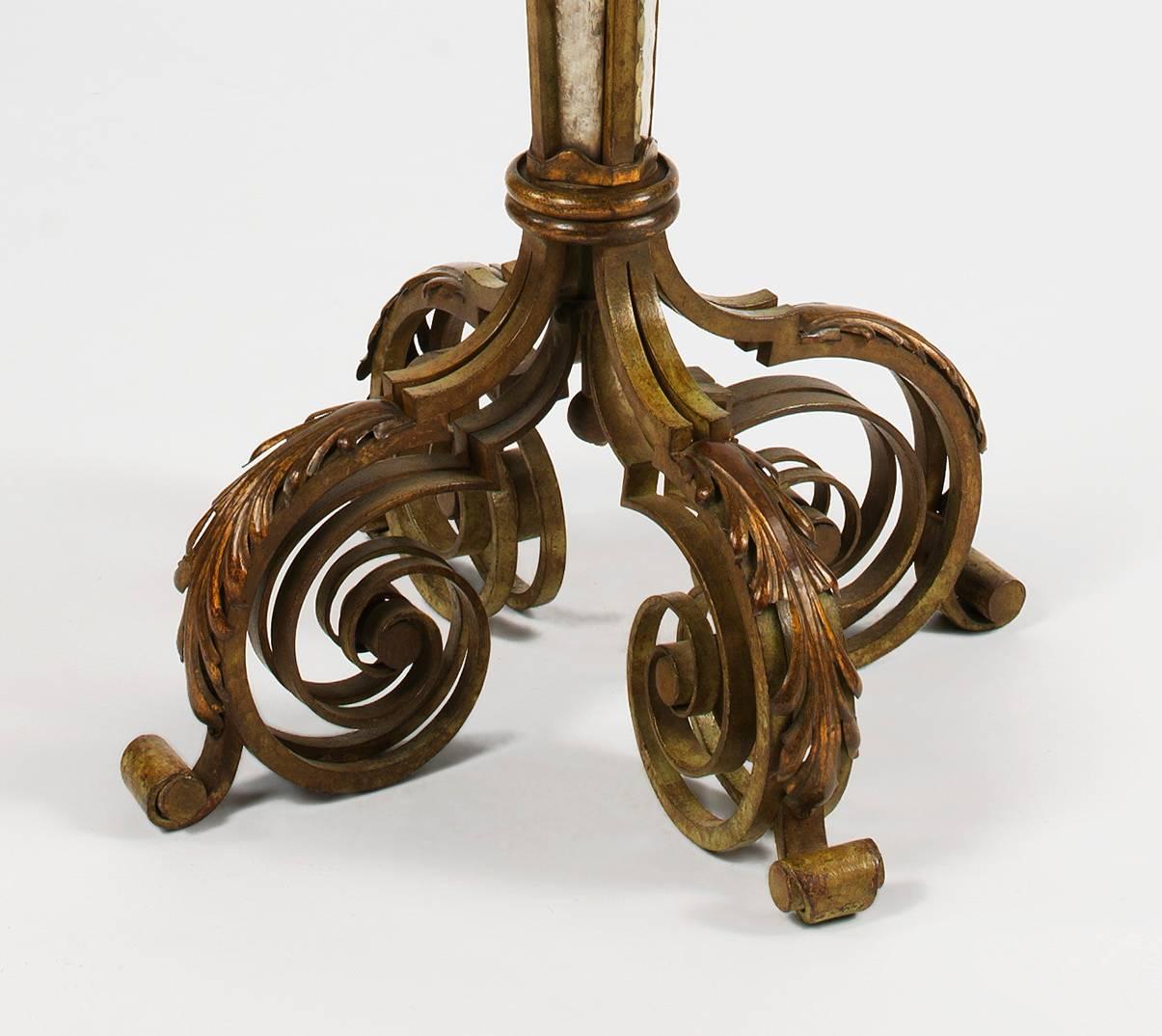 A parcel-gilt wrought iron floor lamp attributed to Serge Roche, inset with four verre églomisé panels by Robert Pansart, surviving in excellent condition.

Serge Roche (1898- 1988) was the greatest exponent of the baroque revival that lasted