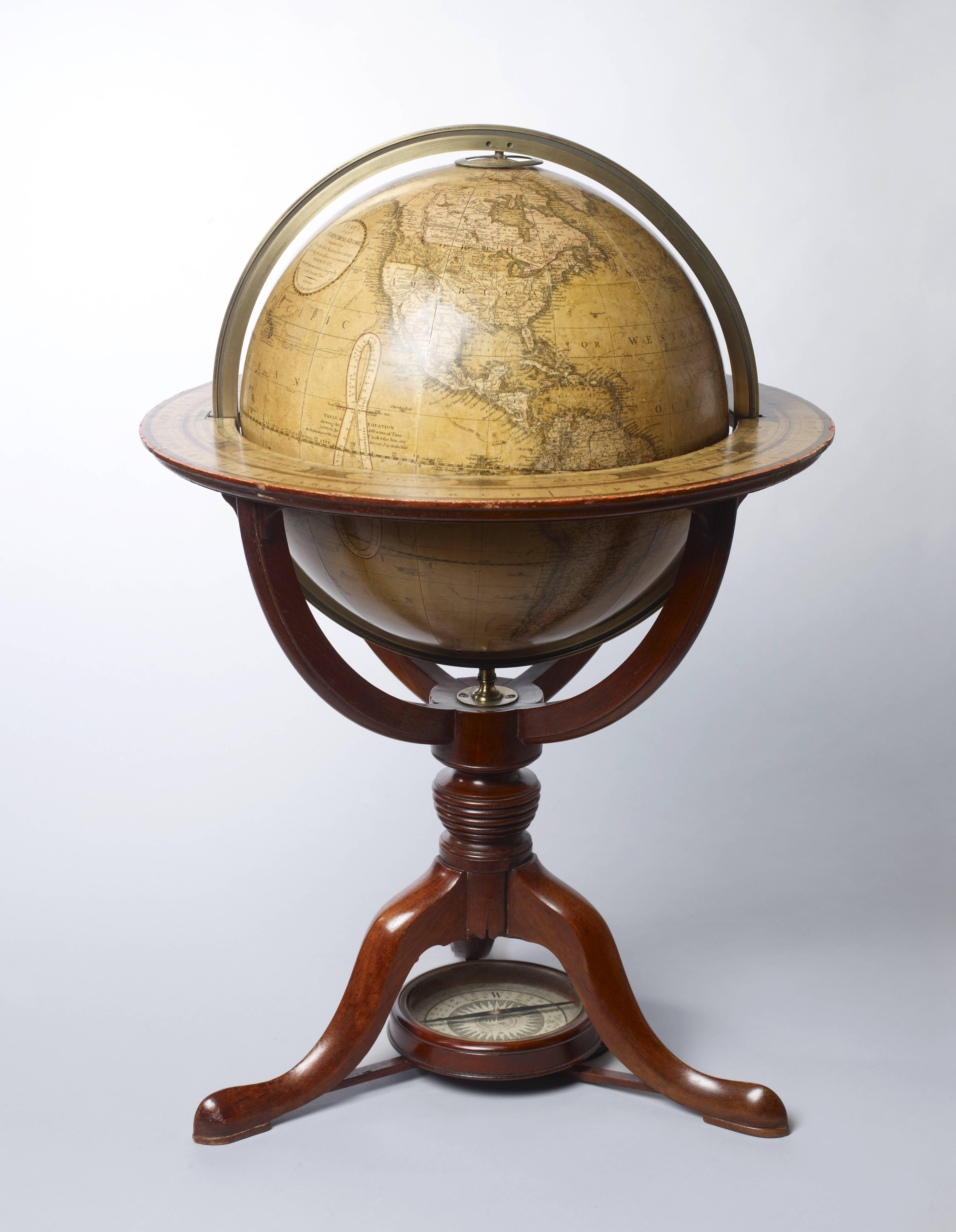 A pair of 8-inch terrestrial and celestial table globes on Regency mahogany stands.