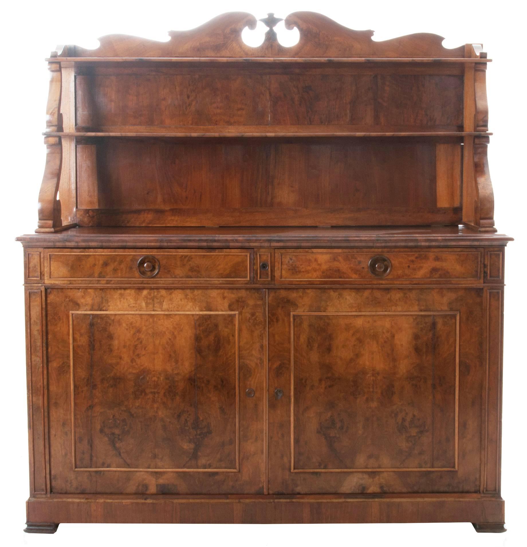 Absolutely handsome Restauration period buffet / server from the 1850s or earlier. The crest at the top is elegantly scalloped and shaped. Sitting over two spacious shelves for stacking your dinner service, held by two elegant scrolled and curved