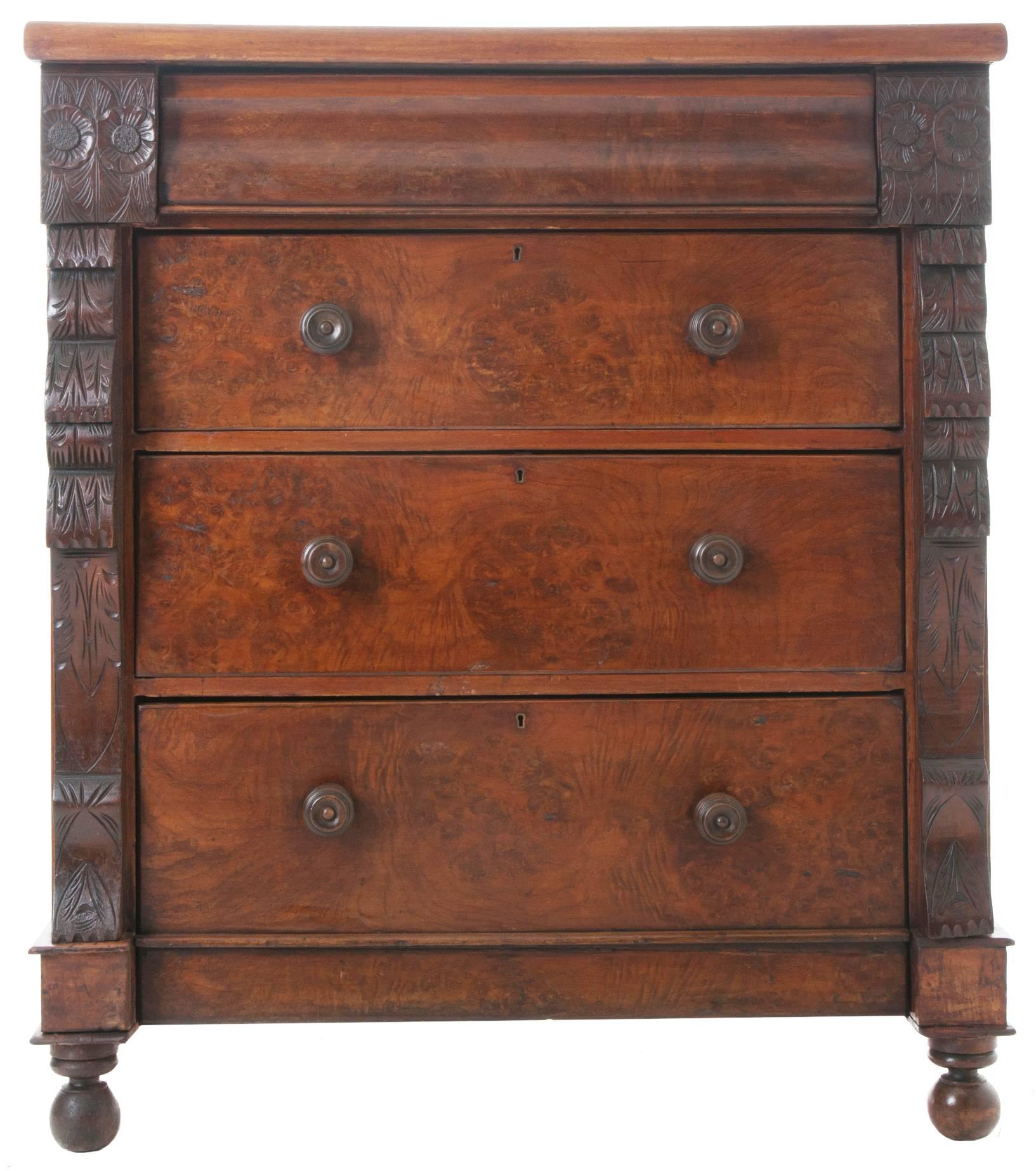Large burled mahogany Scottish chest of drawers with solid mahogany top. Three drawers are across the top, carved sunflowers adorn the small drawers with a longer shaped front drawer in between. Below are three burled front drawers each with two