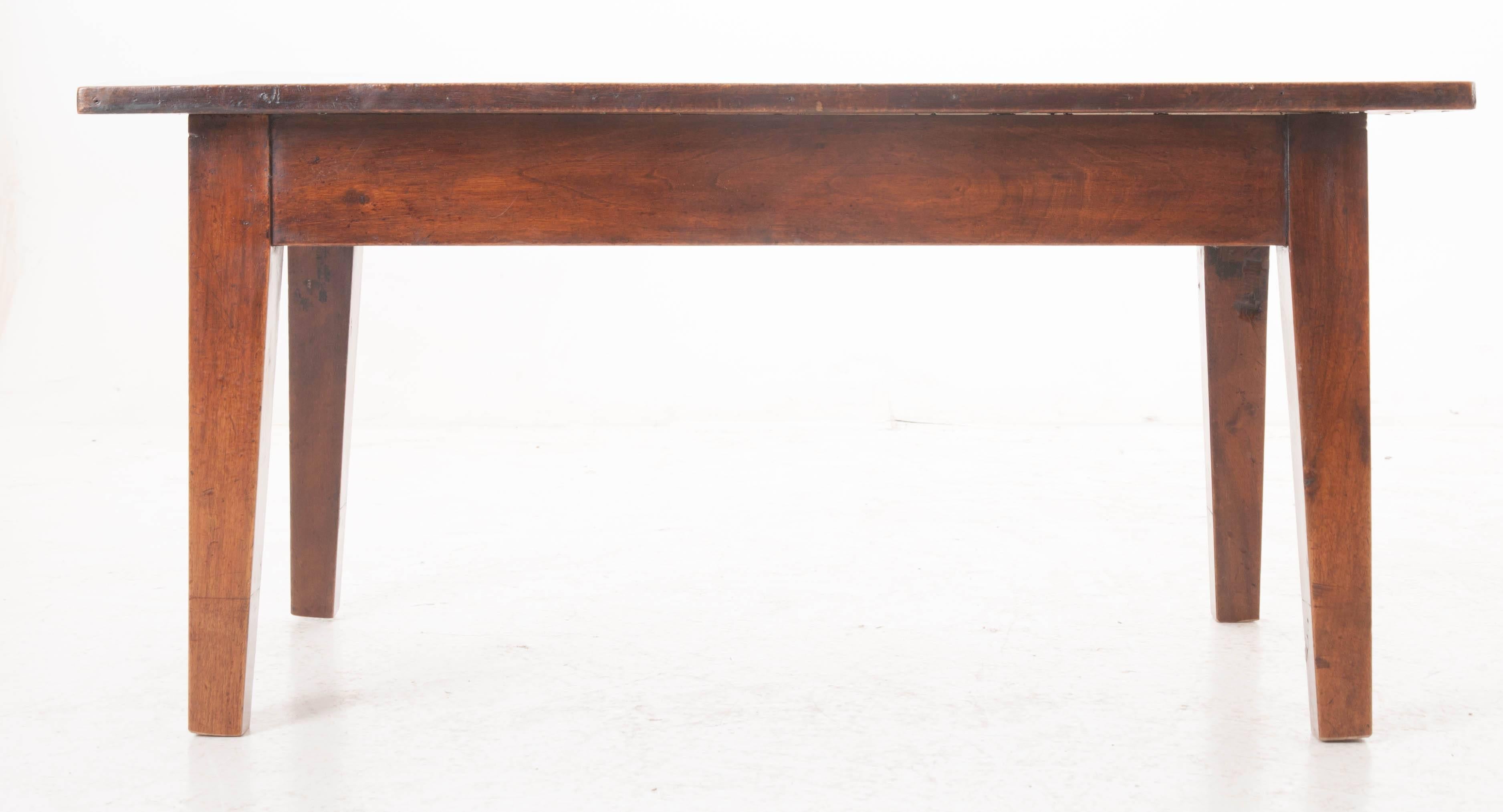 A charming coffee table from 1850s, France. This simple, rustic coffee table is all about warmth and patina. The freshly polished top reveals the grain and character of the beautiful walnut. Time has been good to this piece, as it has only become
