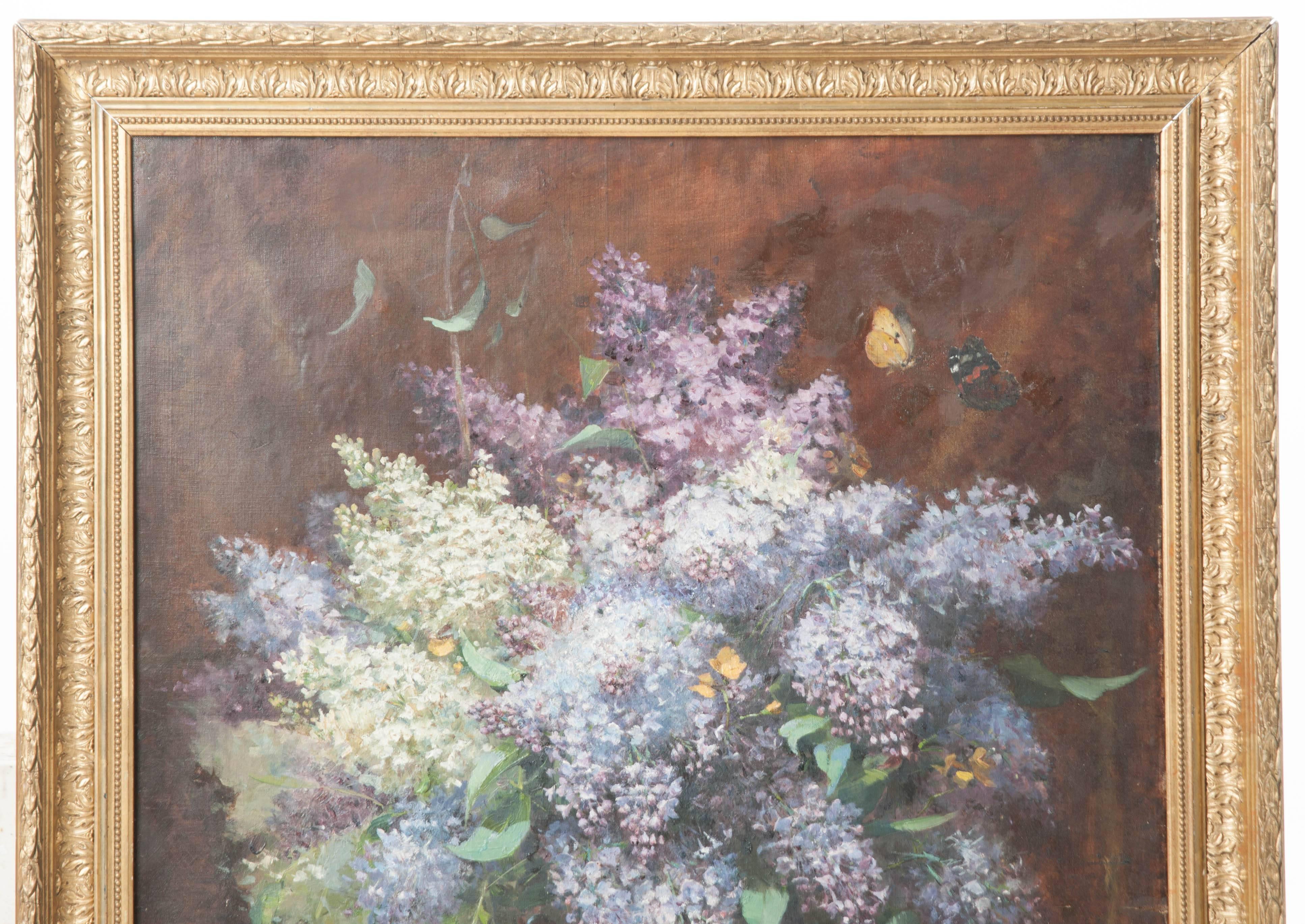 Oil on canvas. Shades of blues and purples dominate this beautiful still life depicting a tabletop vase full of wisteria. Closer inspection reveals butterflies and beetles that may be missed with a quick glance. Framed in an exquisitely carved gilt